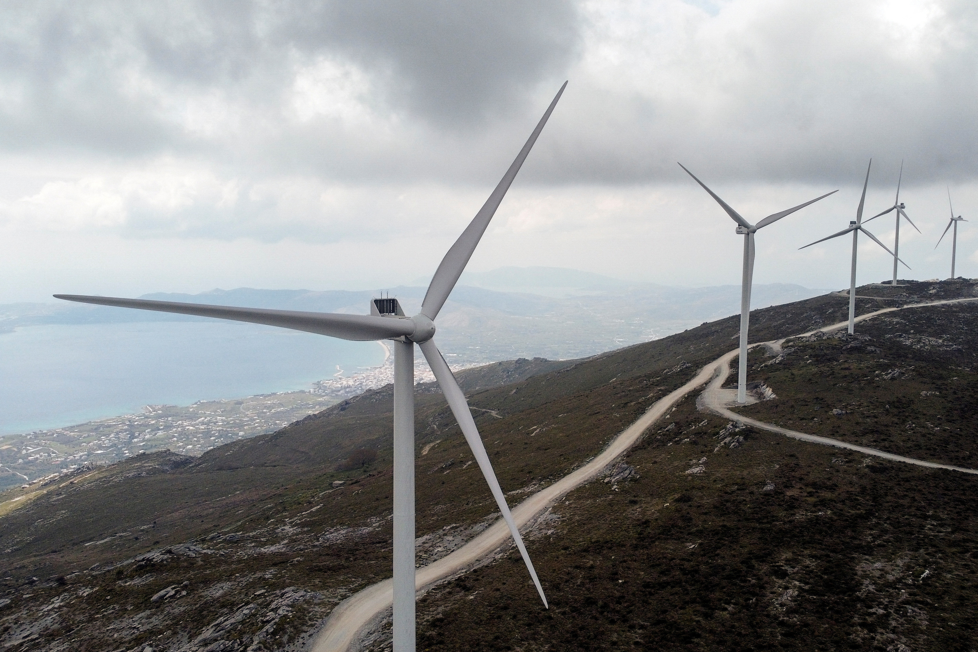 Wind turbines are seen on a mountain near the town of Karystos, on the island of Evia