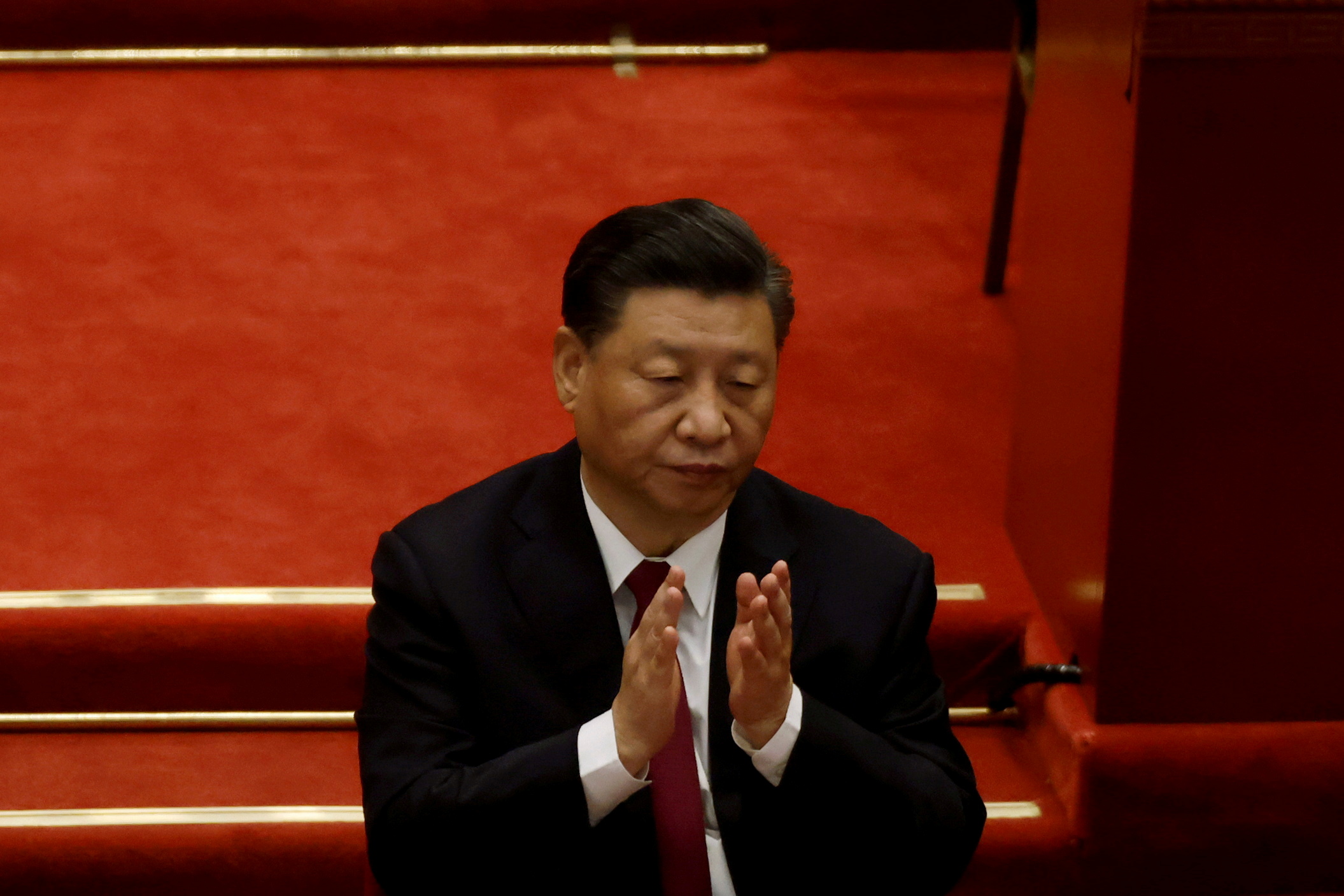 Chinese President Xi Jinping applauds at the opening session of the National People's Congress (NPC) at the Great Hall of the People in Beijing, China March 5, 2021