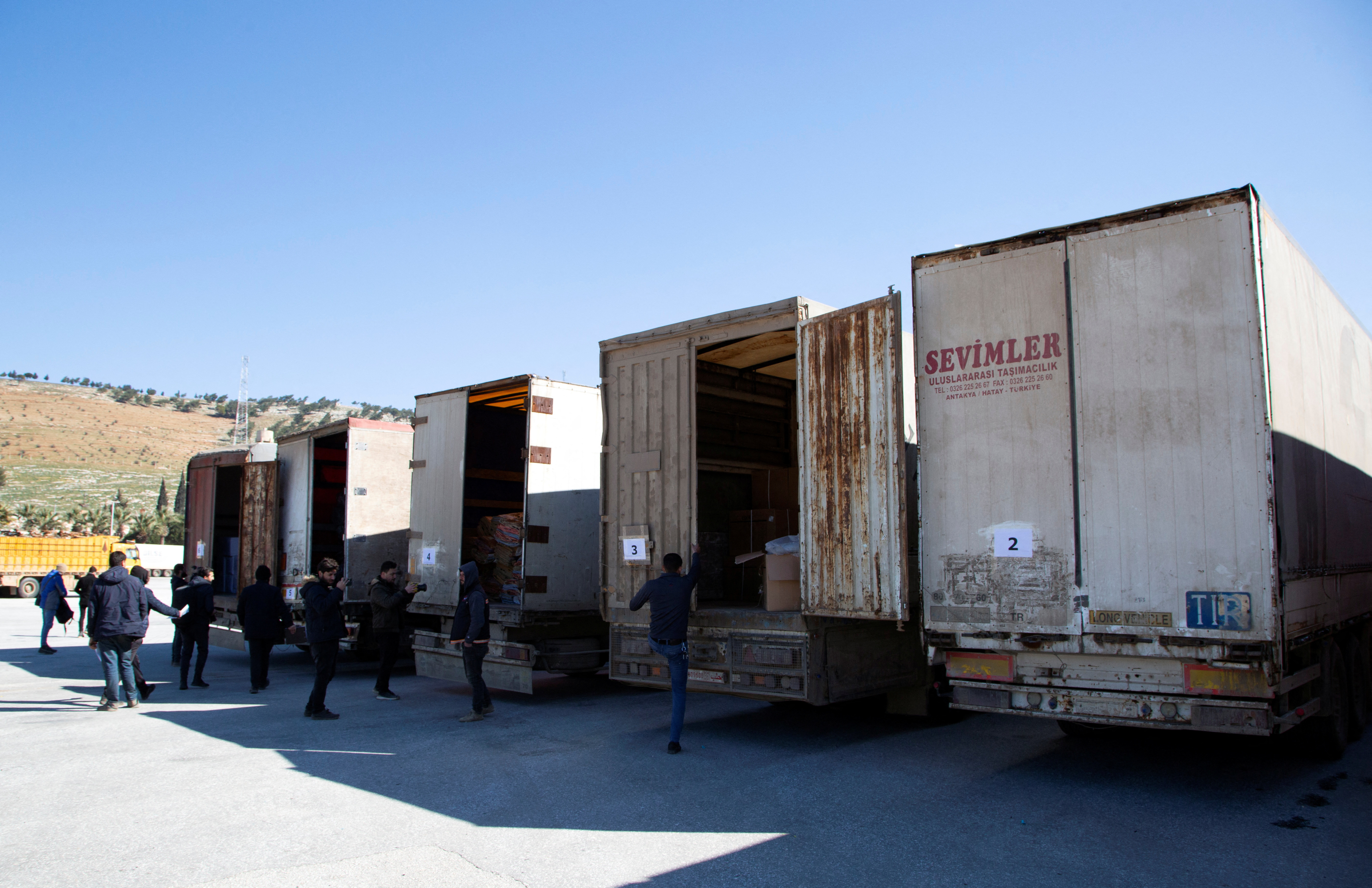 Trucks carrying humanitarian aid are seen at the Bab al Hawa border crossing