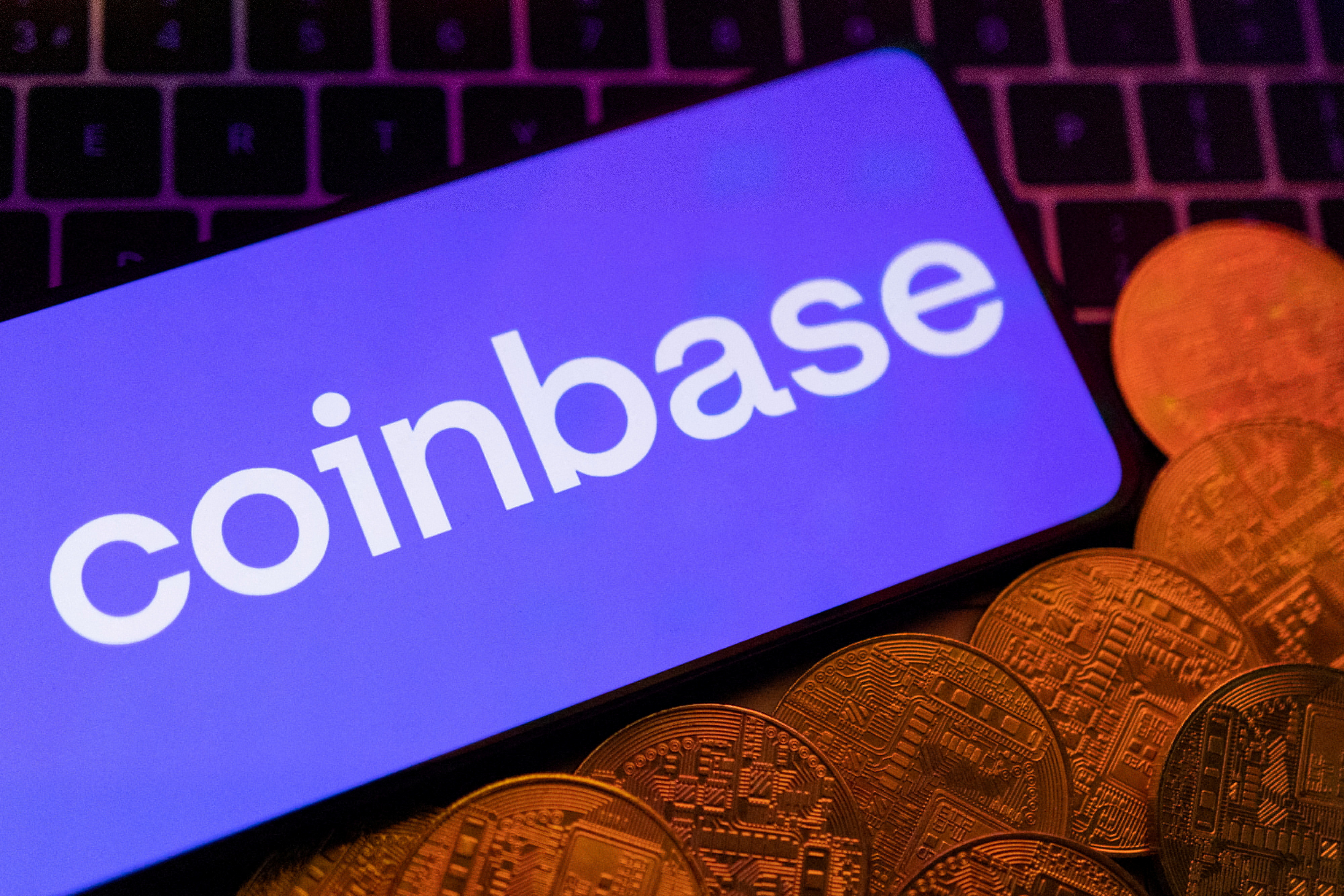 Illustration shows smartphone with displayed Coinbase logo