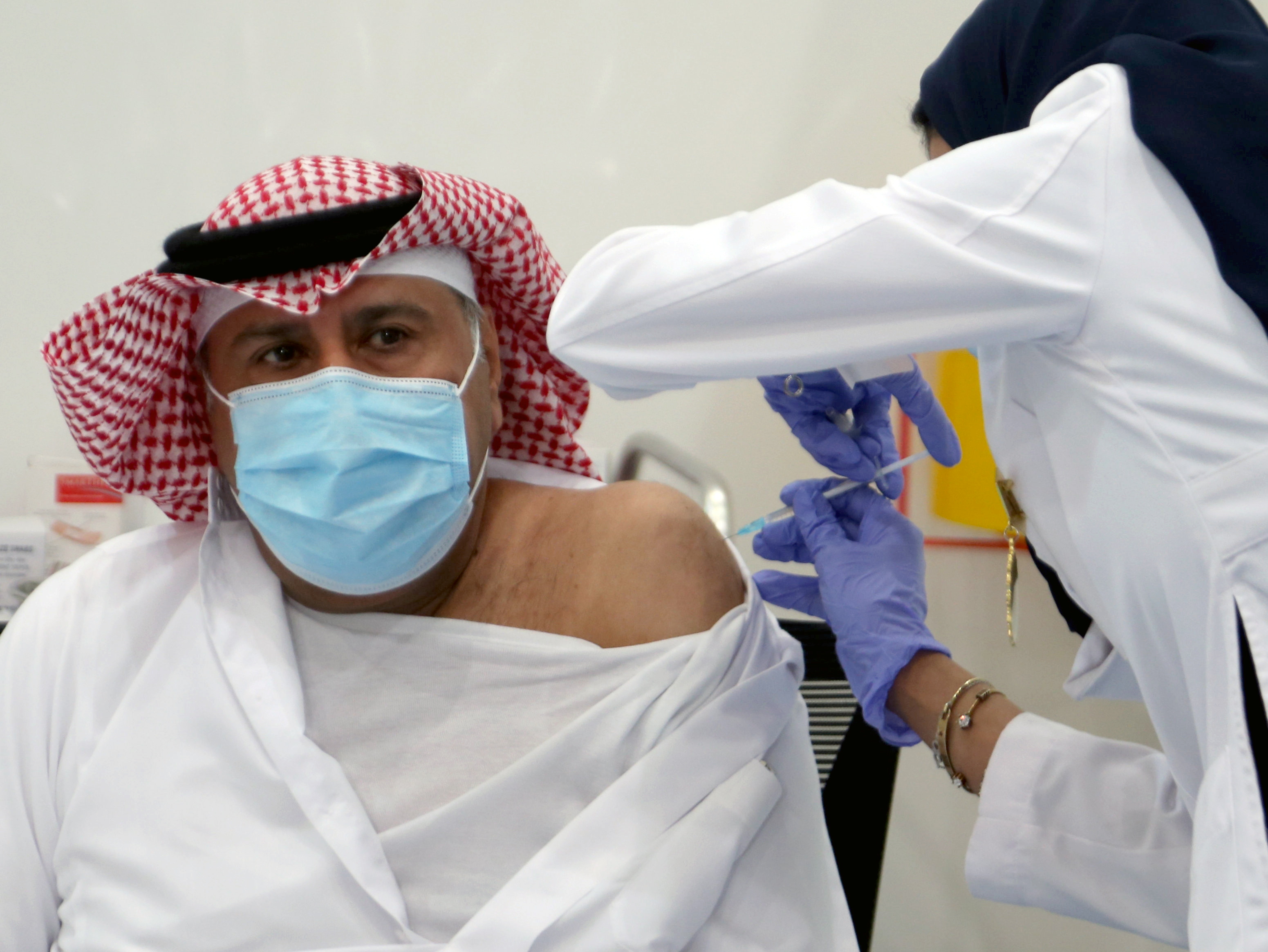 A Saudi man gets a dose of a coronavirus disease (COVID-19) vaccine, in Riyadh