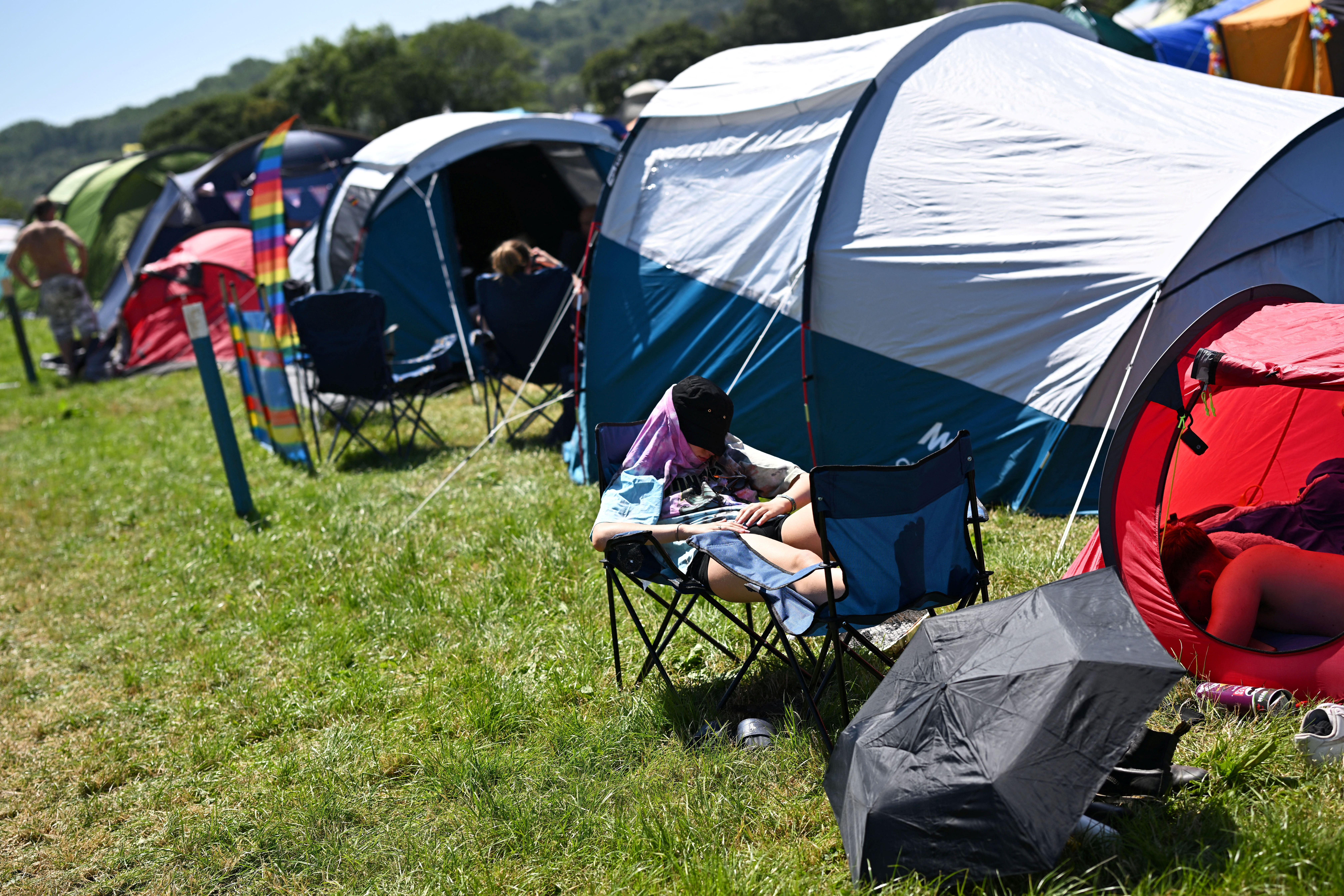 Revellers rest at Worthy Farm in Somerset during the Glastonbury Festival
