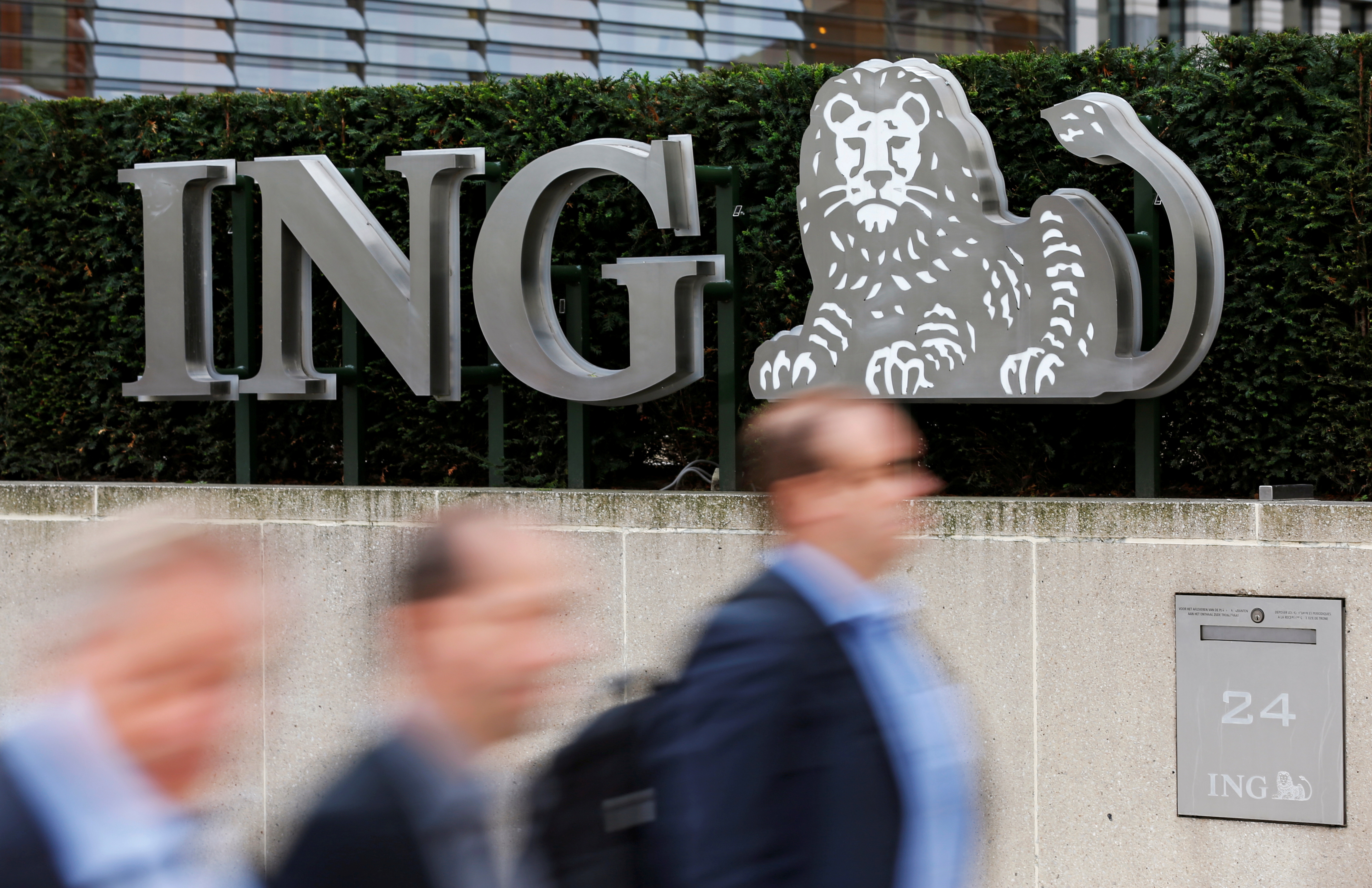 Pedestrians walk past the logo of ING bank by the group's main office in Brussels