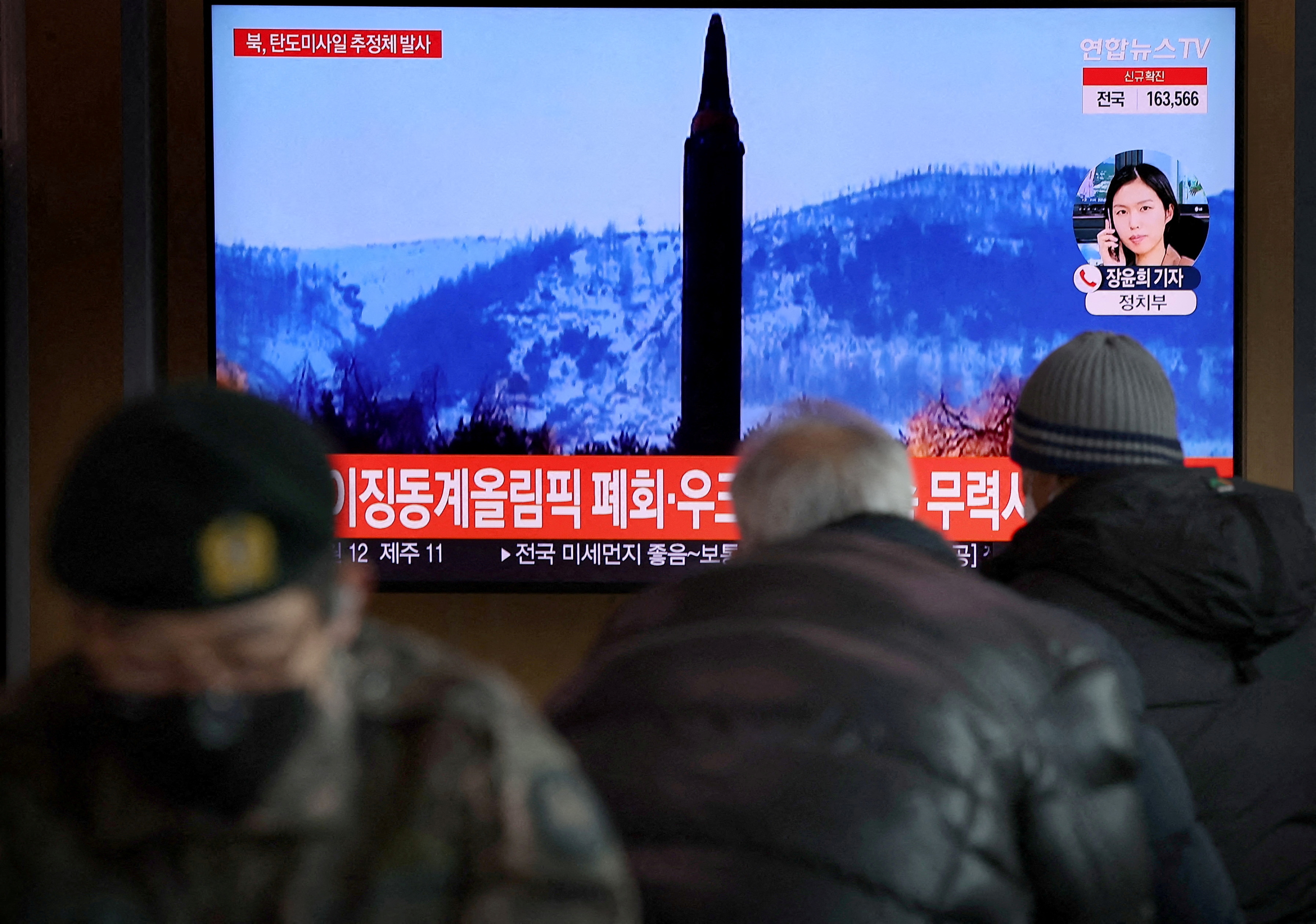 People watch a TV broadcasting file footage of a news report on North Korea firing what appeared to be a ballistic missile, in Seoul