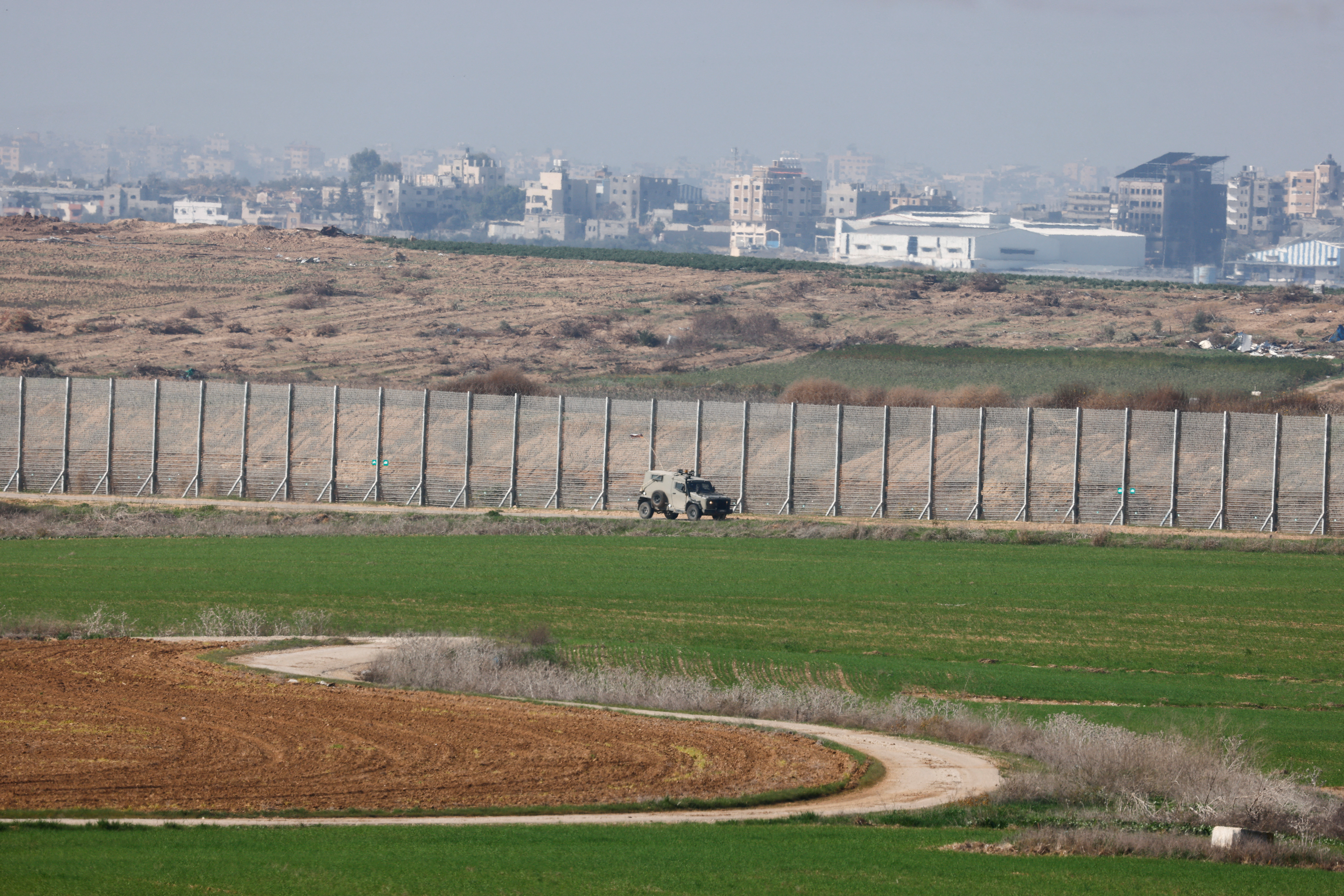 An Israeli army vehicle drives along the border with central Gaza, in southern Israel