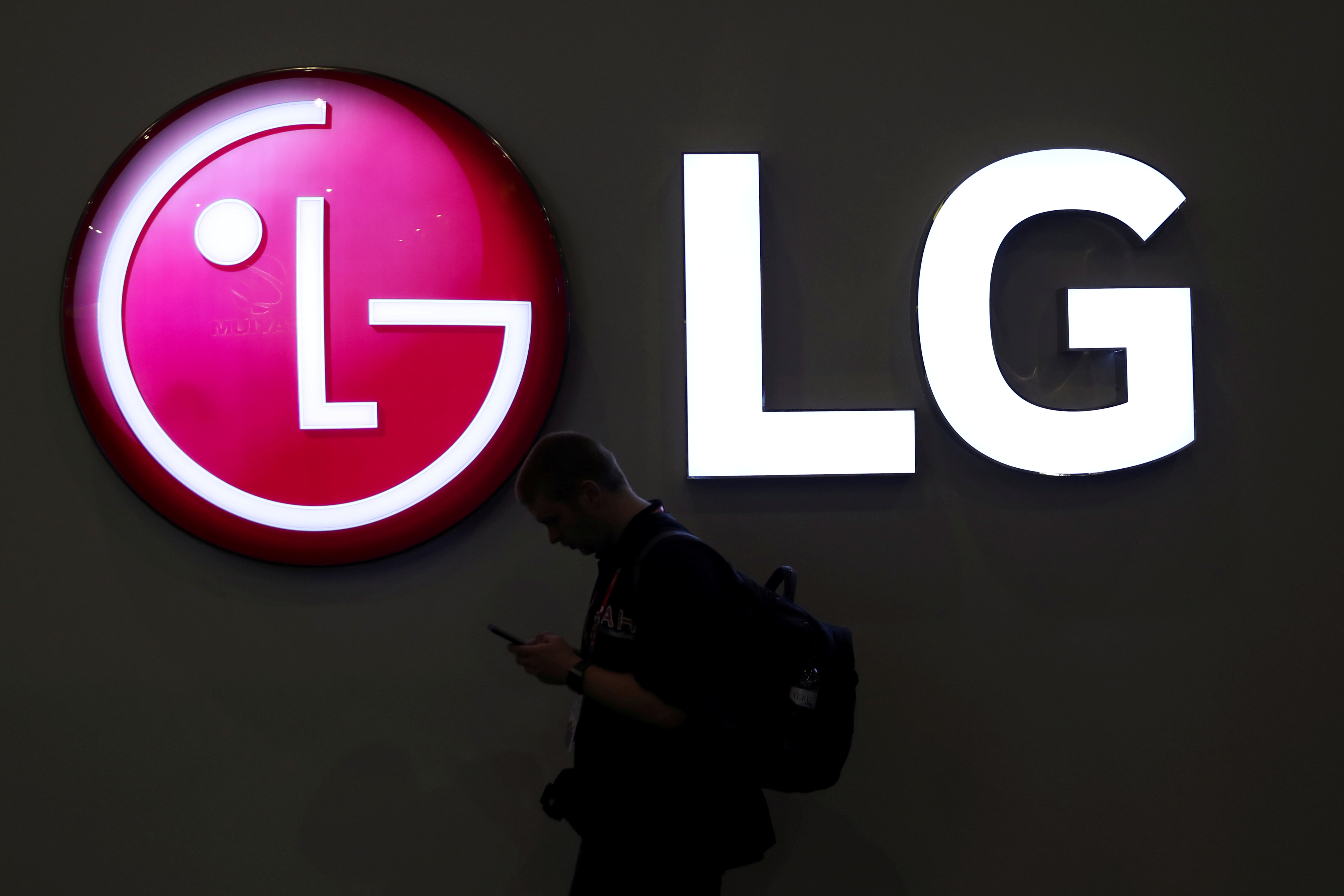 A man walks past an LG logo at the Mobile World Congress in Barcelona