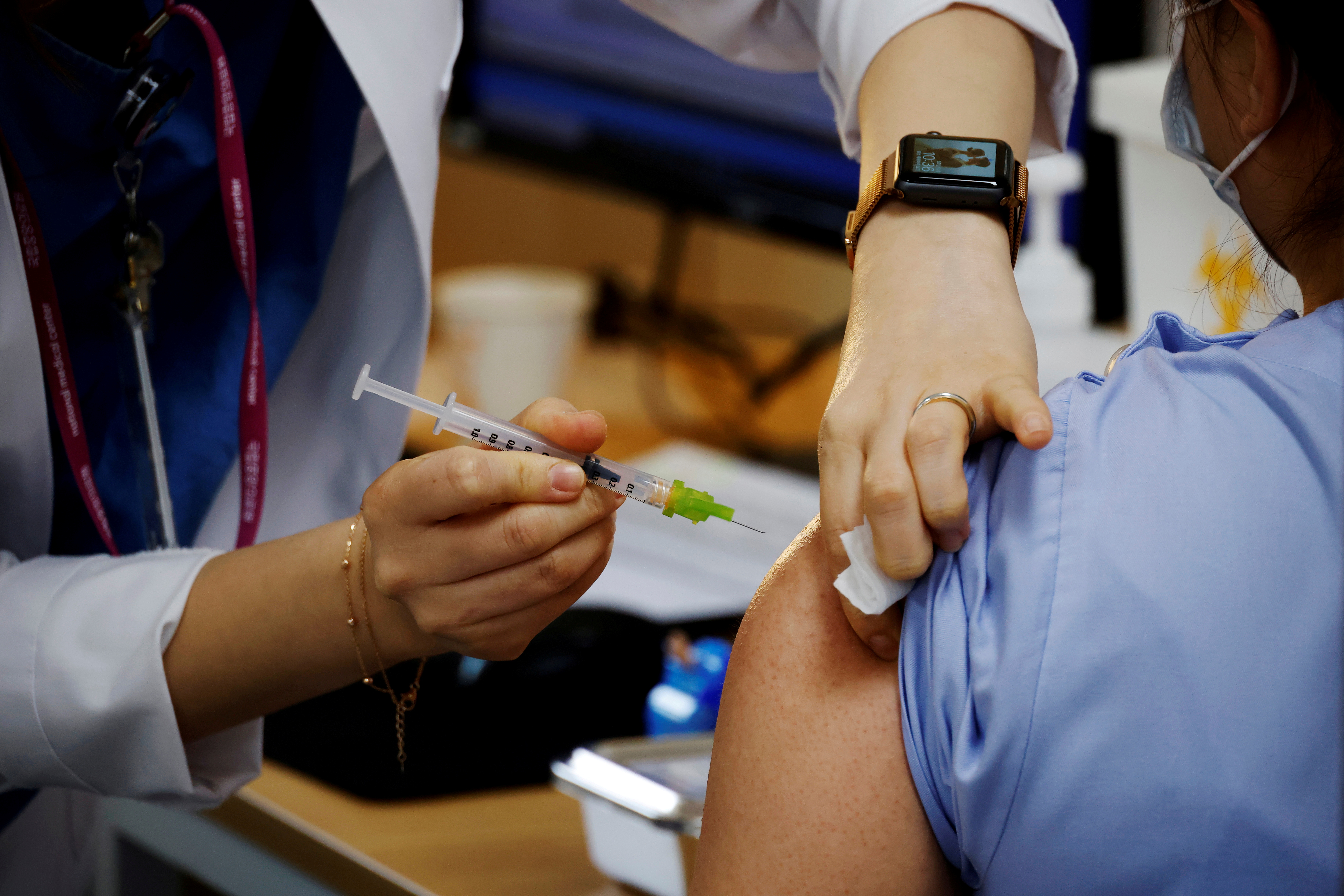 A health worker gets a dose of the Pfizer-BioNTech coronavirus disease (COVID-19) vaccine at a COVID-19 vaccination center in Seoul