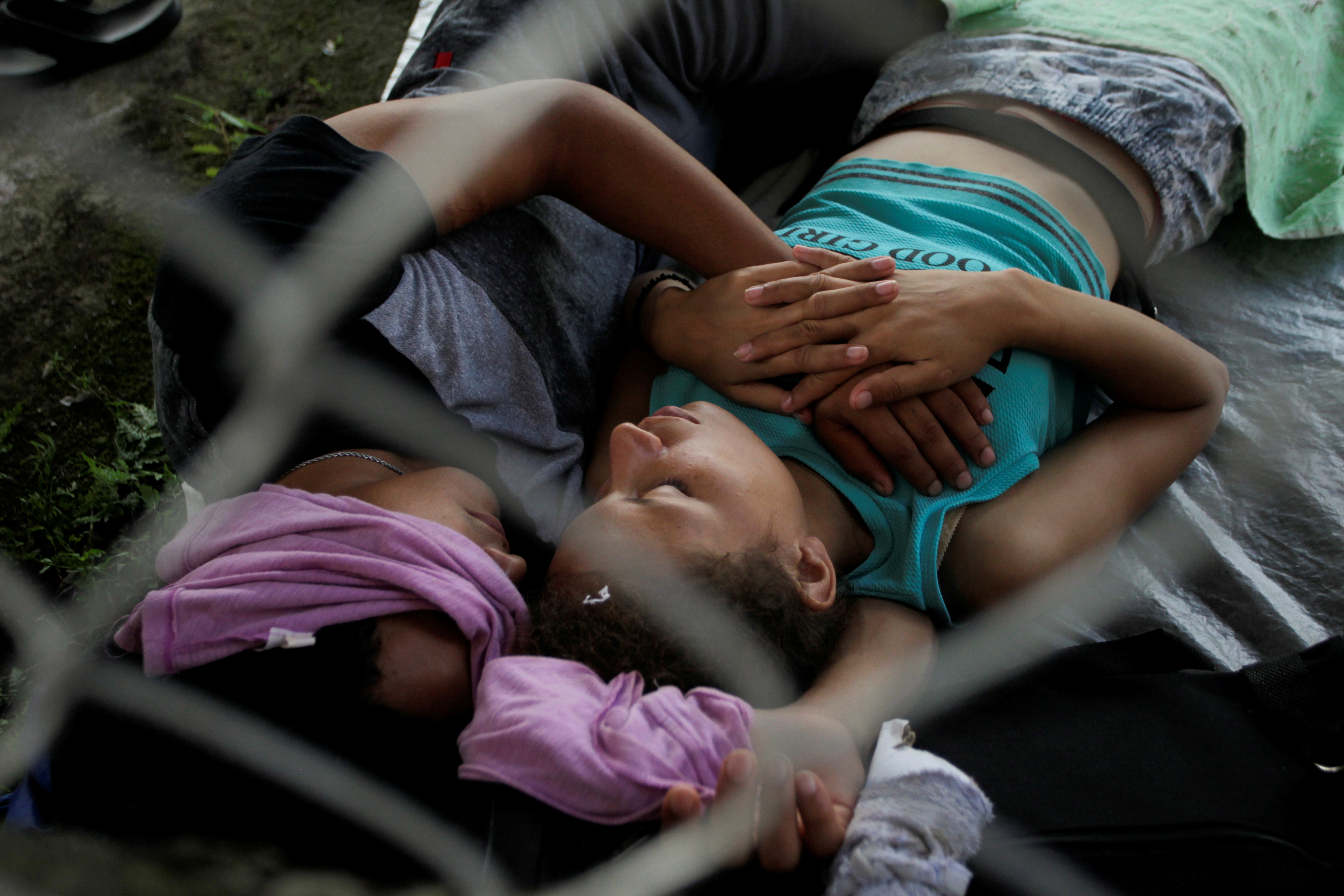 Migrants rest before they continue walking in a caravan heading to Mexico City, in Consuelo Ulapa