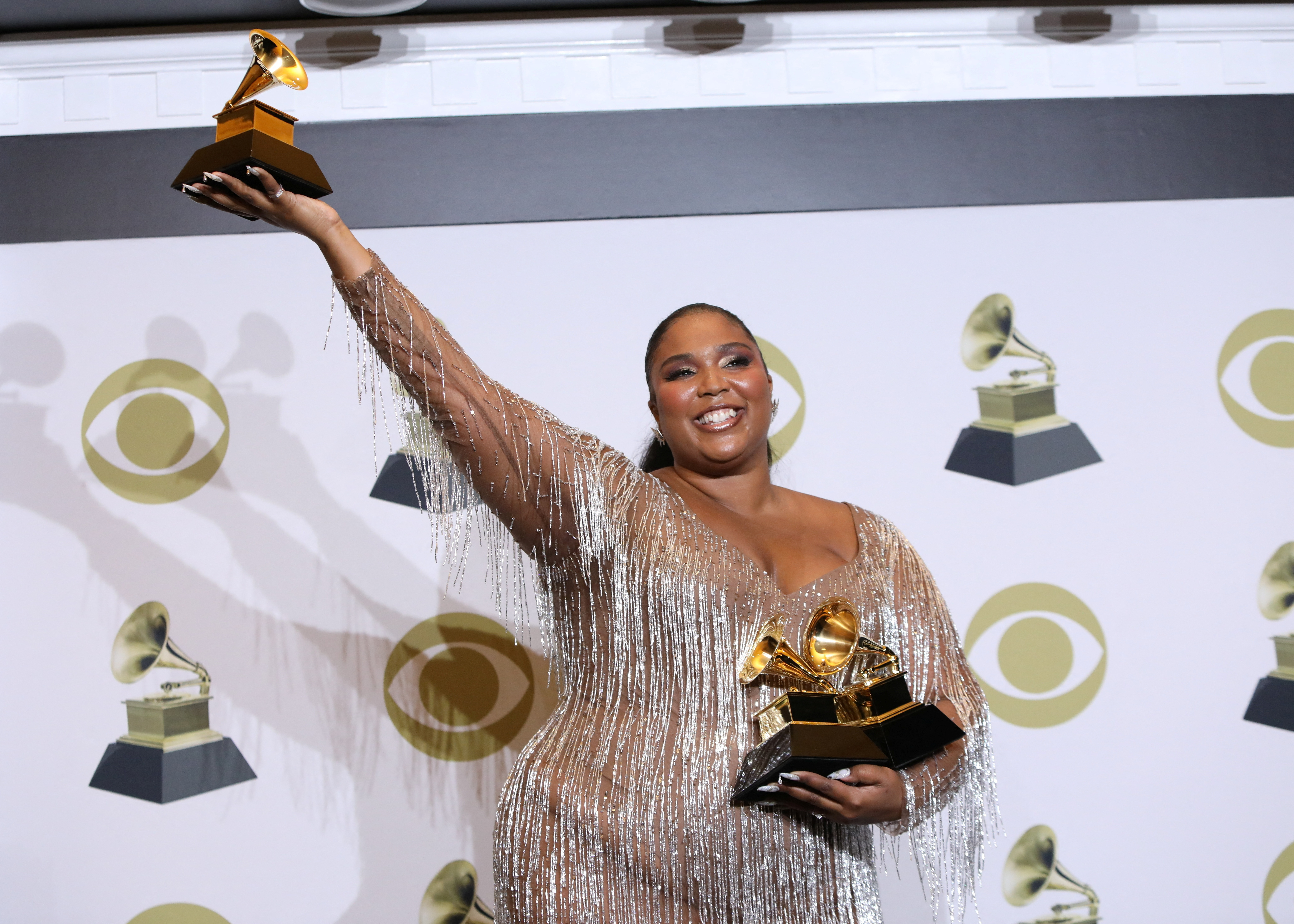 Lizzo poses backstage with her Best Pop Solo Performance award at the 62nd Grammy Awards