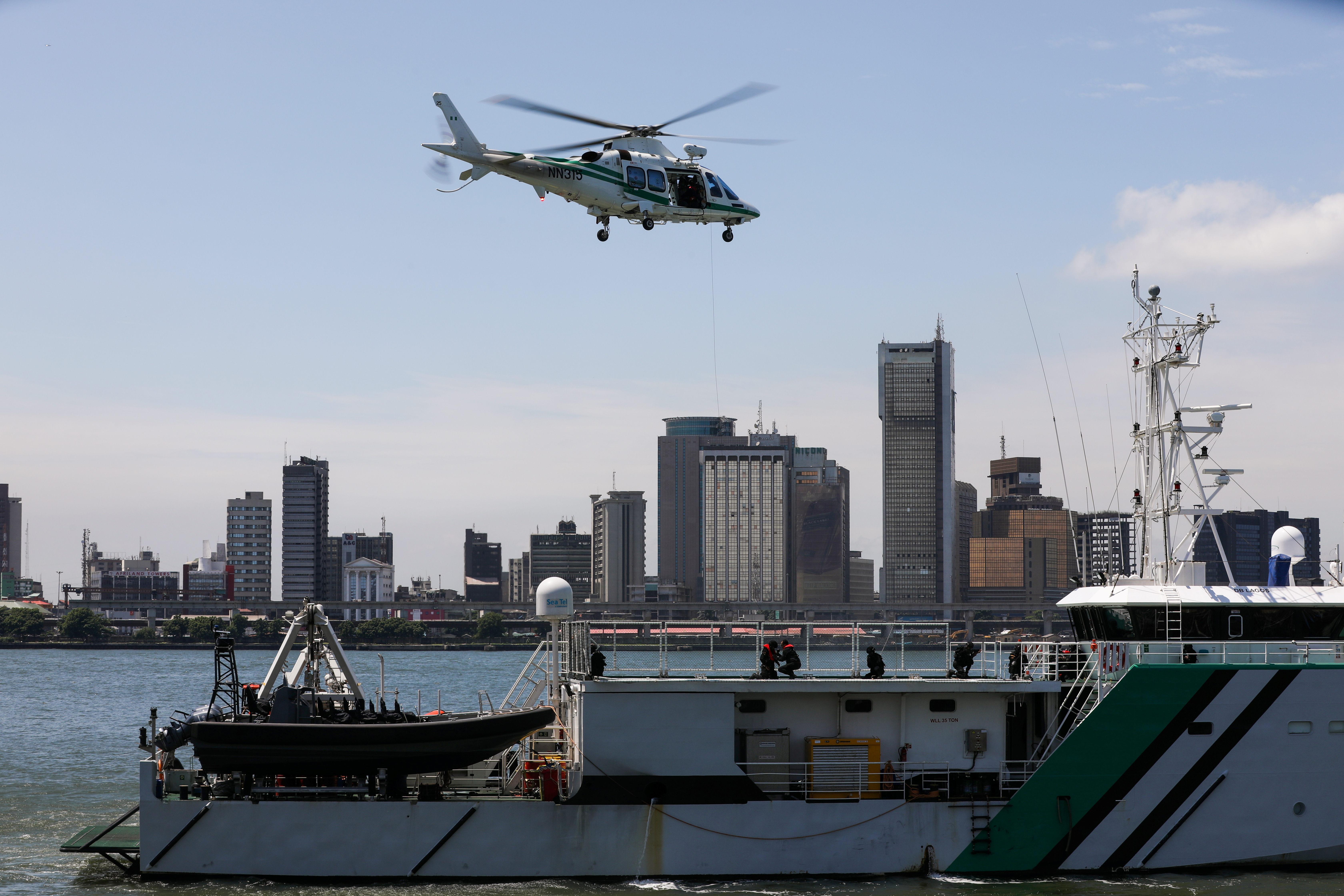 A helicopter from the Maritime Security Unit prepares to rescue members of the unit as they stage an anti-piracy drill during the launch of the Deep Blue project by the Nigerian government in Apapa, Lagos