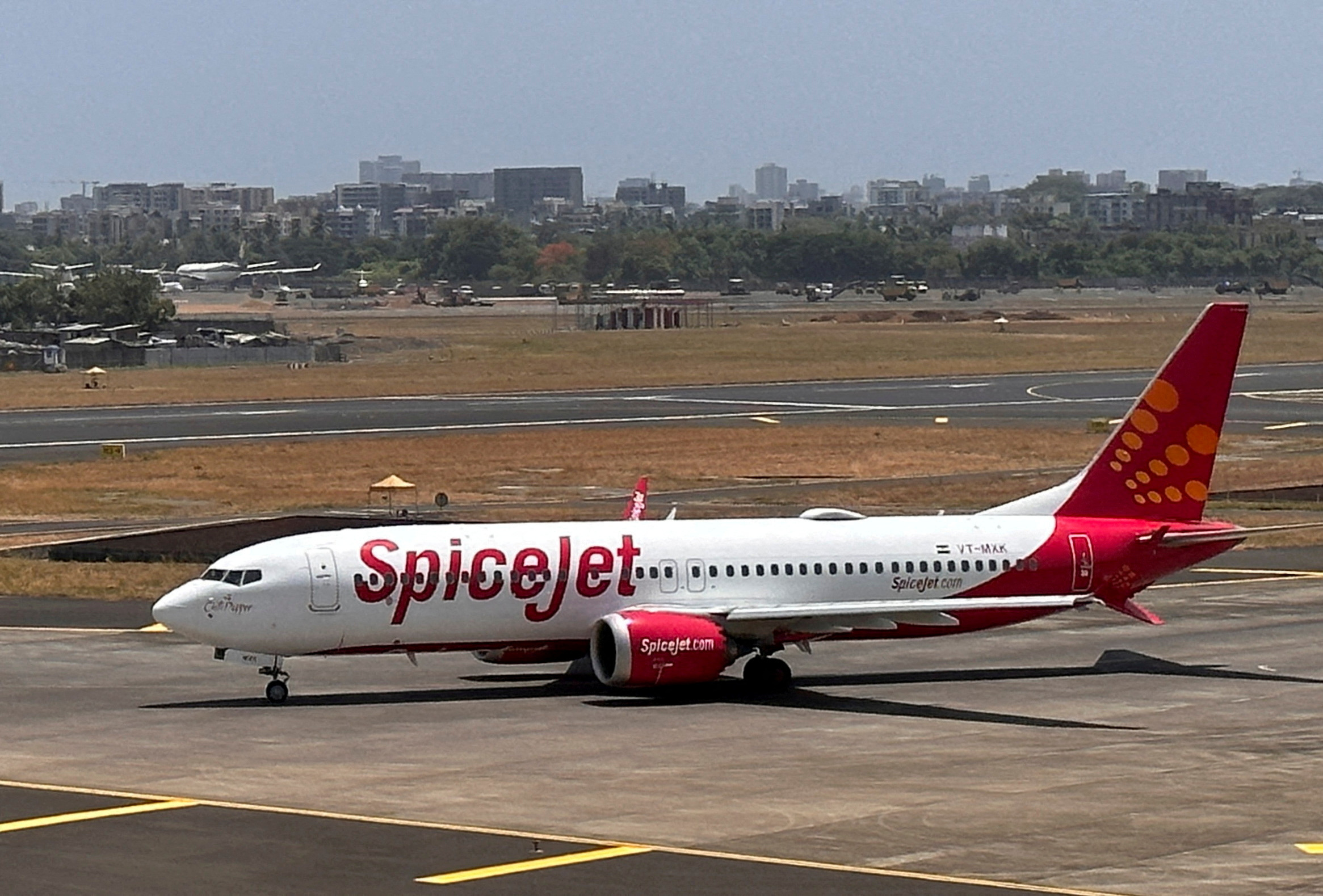 A SpiceJet passenger aircraft taxis on the tarmac at Chhatrapati Shivaji International Airport in Mumbai, India