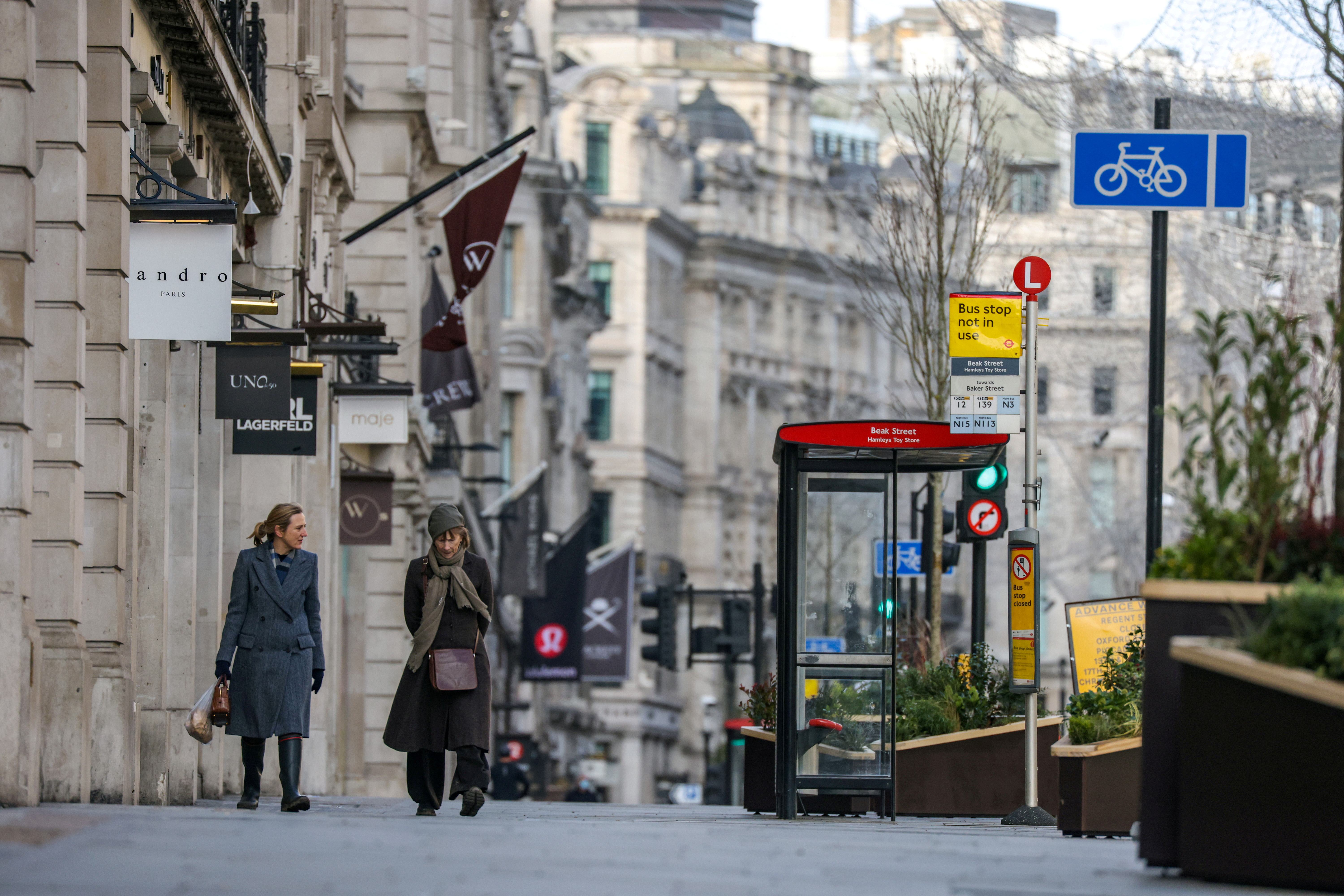 Two women walk down Regent Street in London