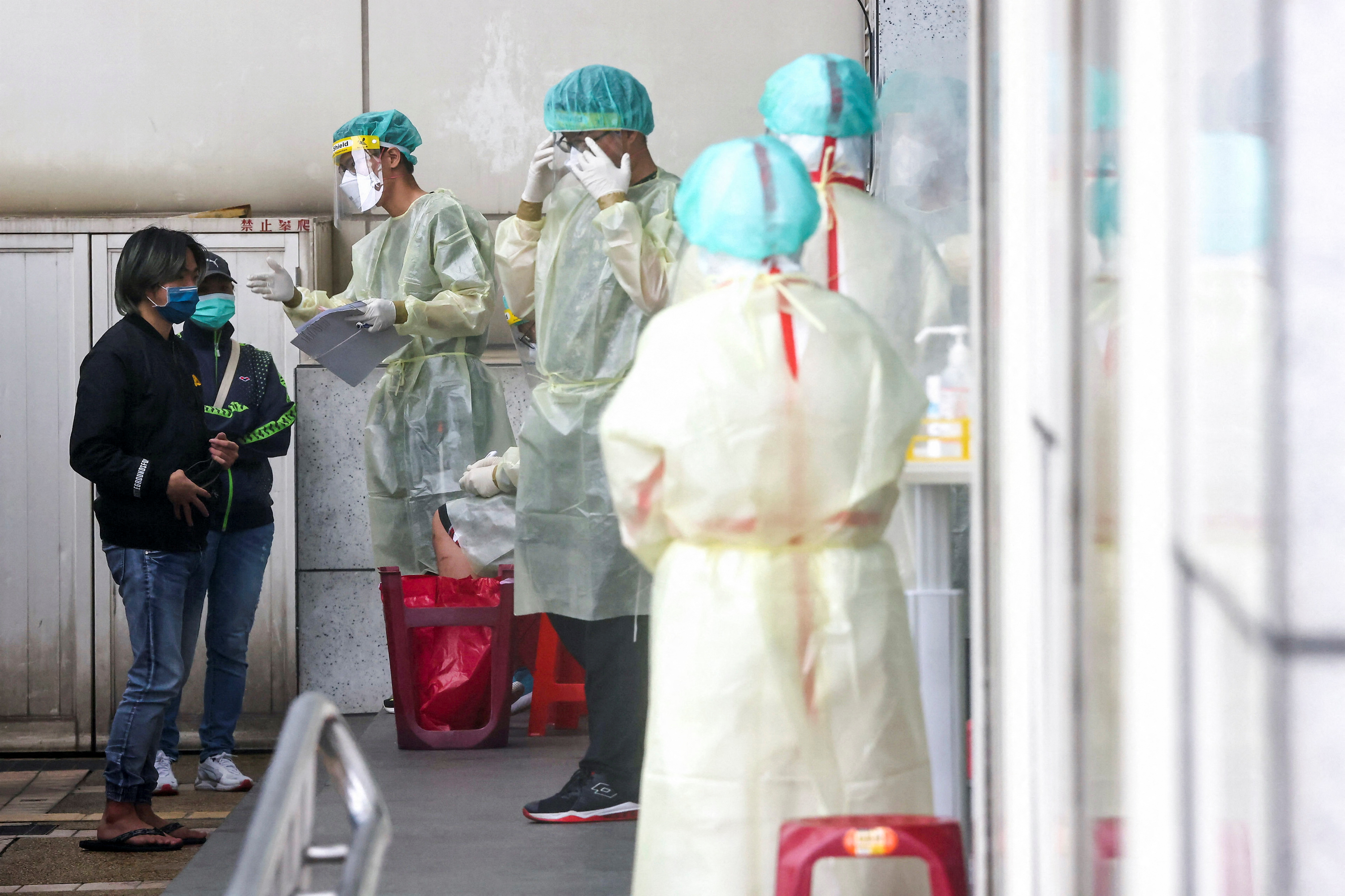 People wait to get a coronavirus disease (COVID-19) test, in Taipei