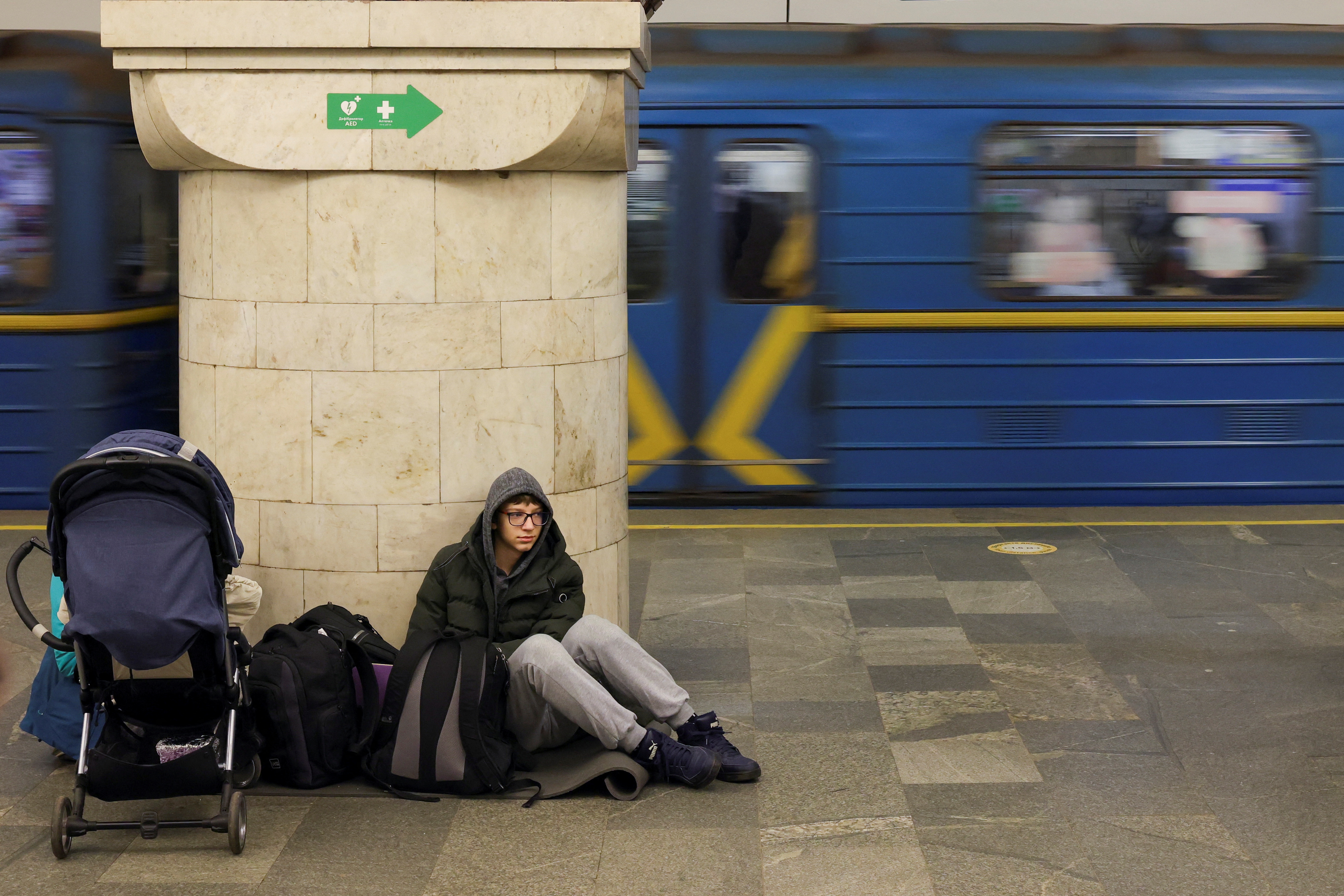 A boy sits at Kyiv metro station