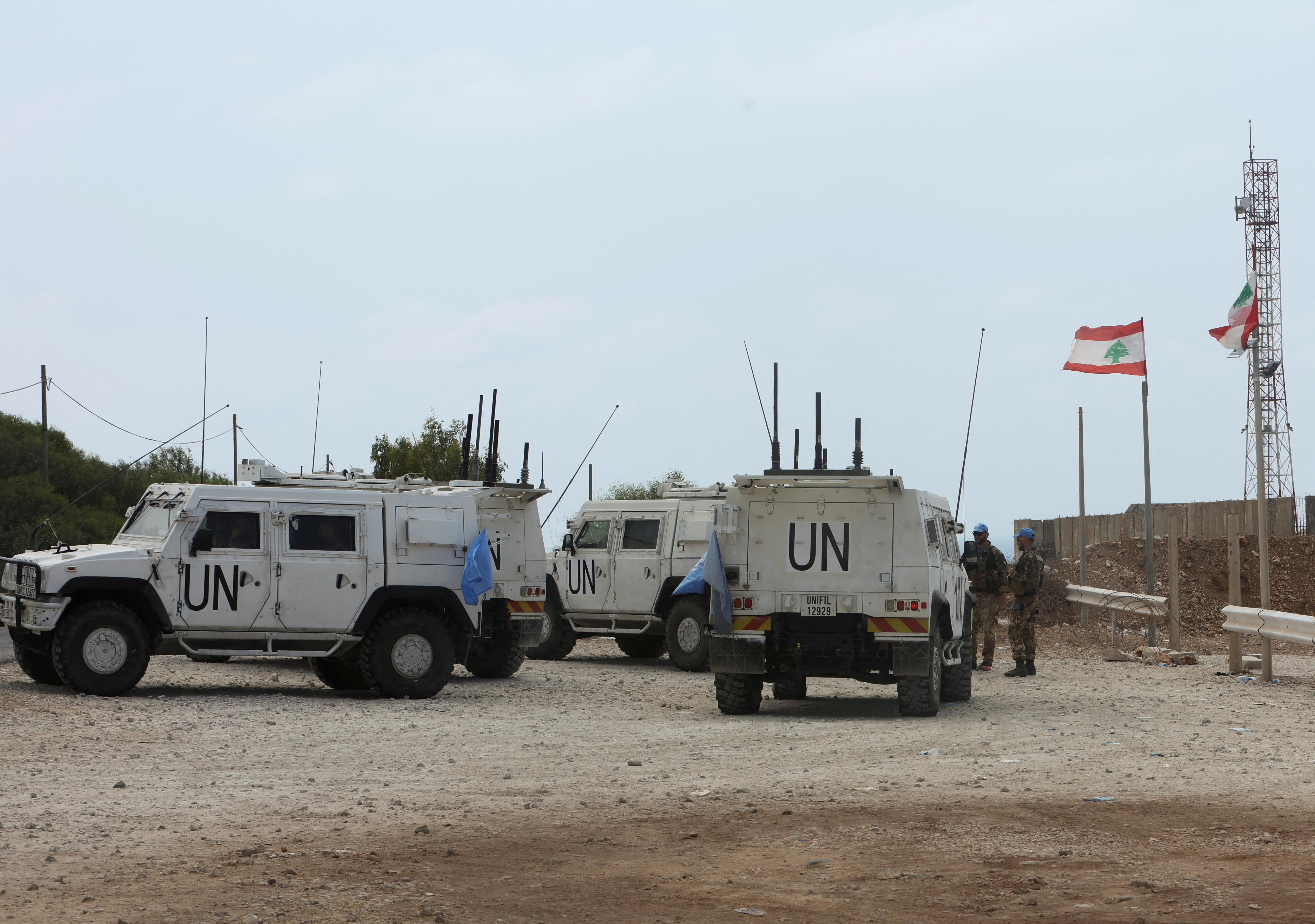 UN peacekeeping force members stand near their vehicles in Naqoura near the Lebanese-Israeli border