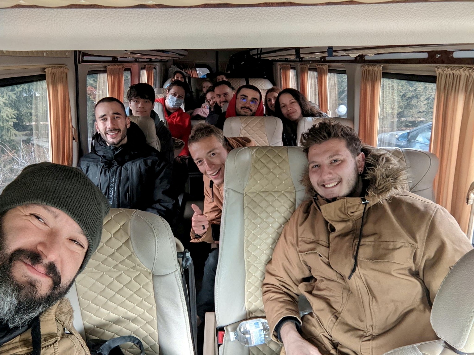 A group picture shows American evacuees on a bus as they prepare to leave Kyiv