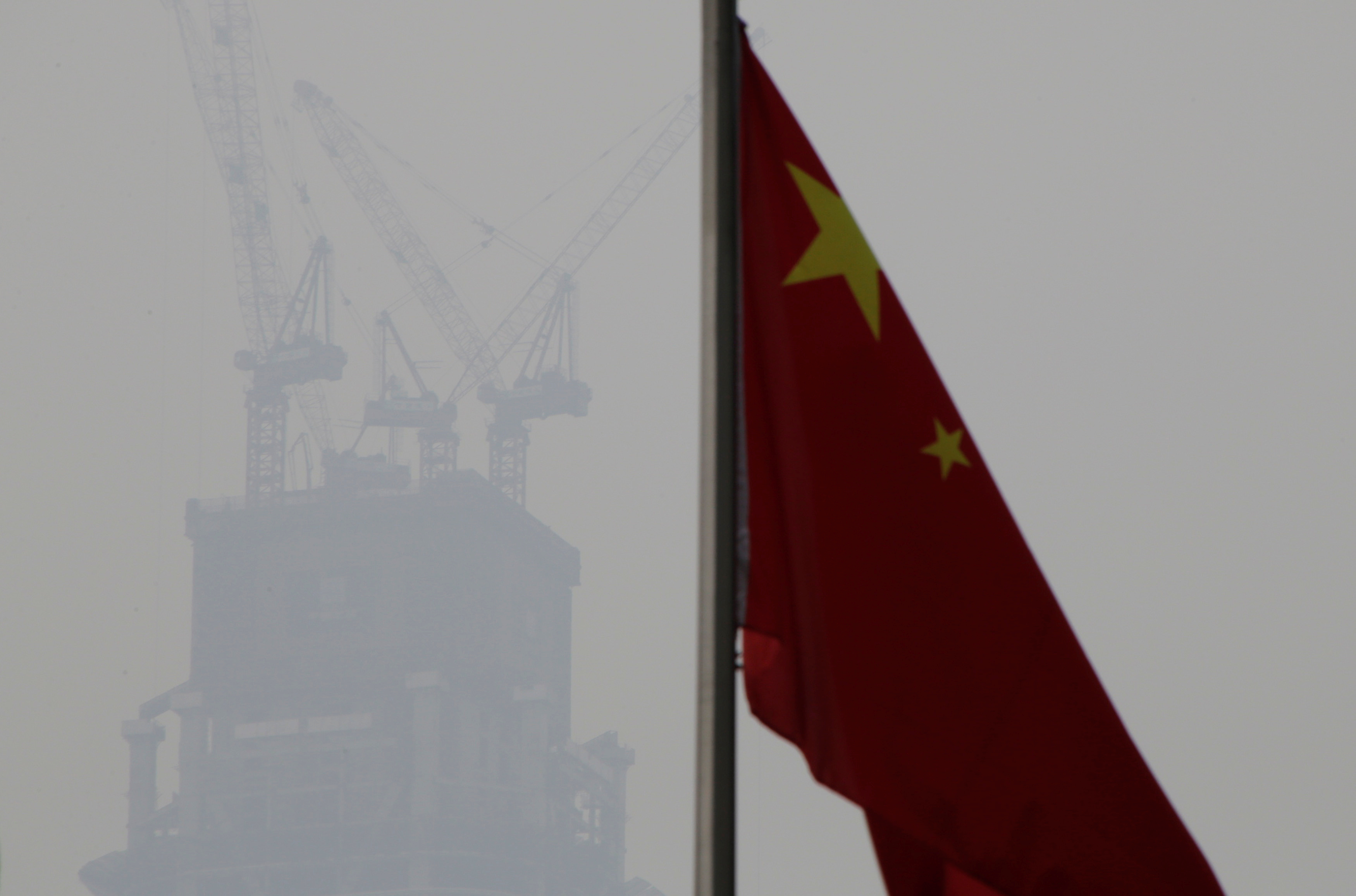 A Chinese flag is seen near a construction site in Beijing's central business area