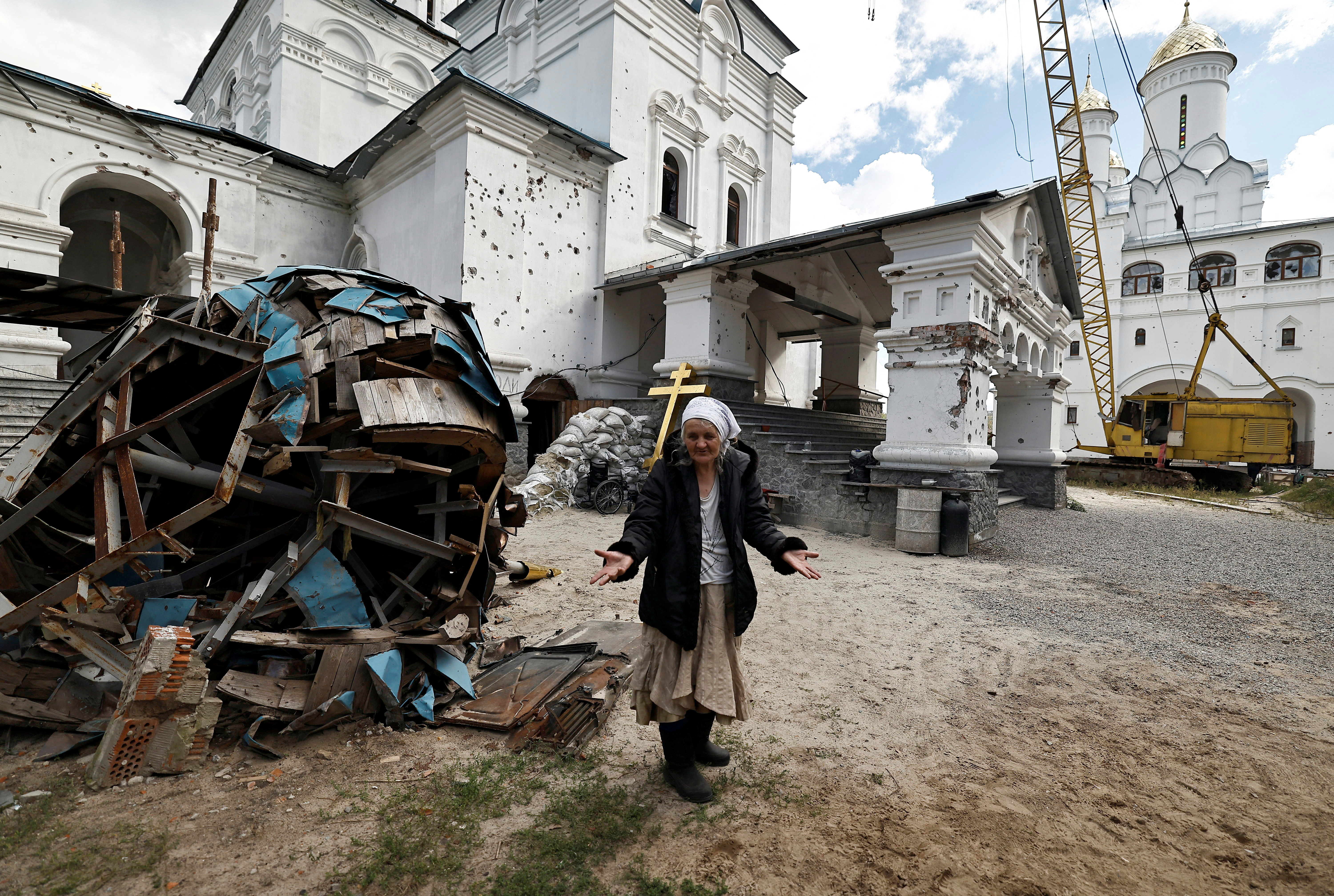 Lyudmiyla, 64, who sheltered for weeks in the basement of the Lavra monastery complex with other Ukrainians, speaks to journalists outside the church in Svyatohirsk