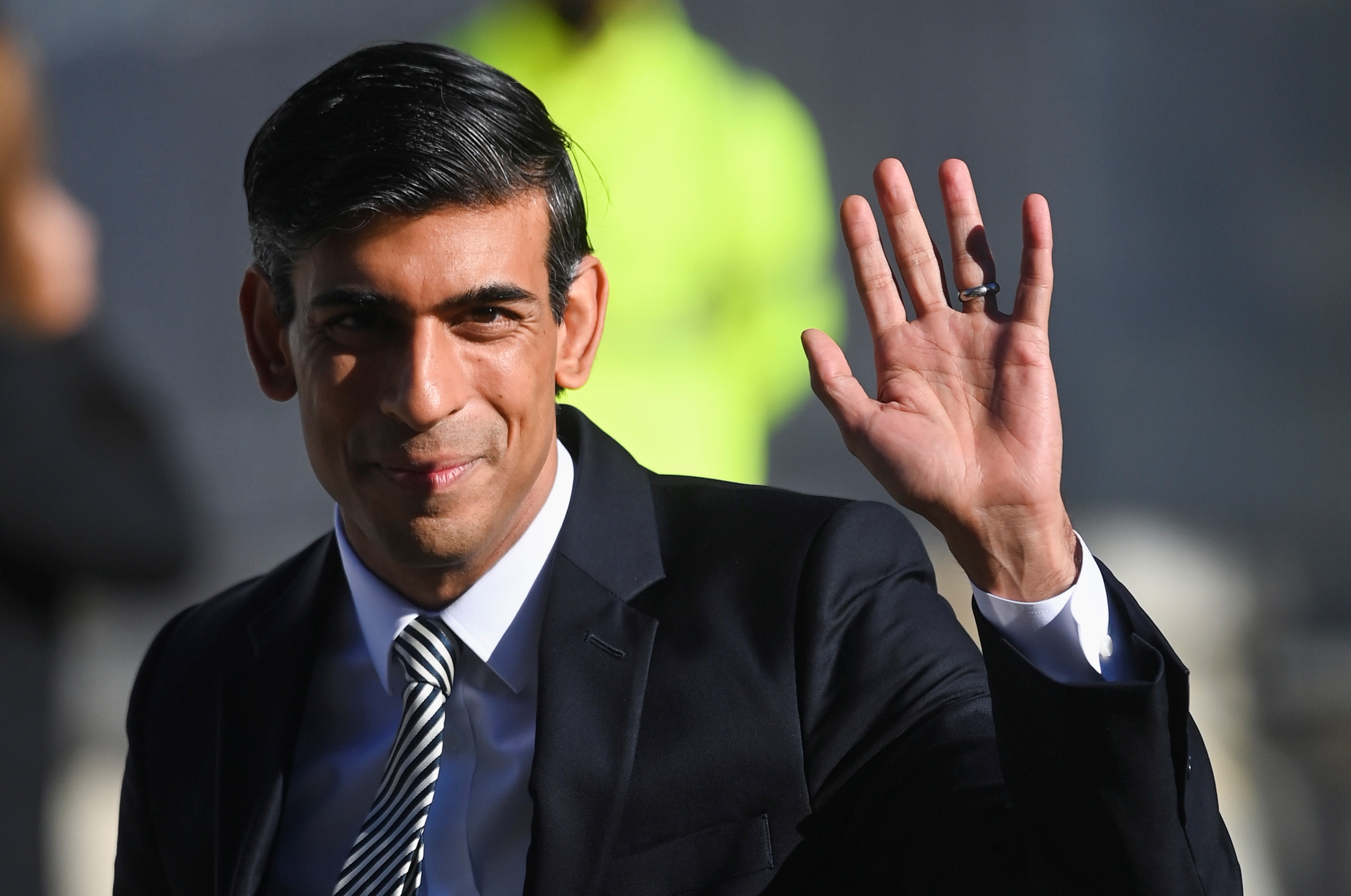 Britain's Chancellor of the Exchequer Rishi Sunak waves as he arrives to attend the annual Conservative Party Conference, in Manchester, Britain, October 6, 2021. REUTERS/Toby Melville/Files