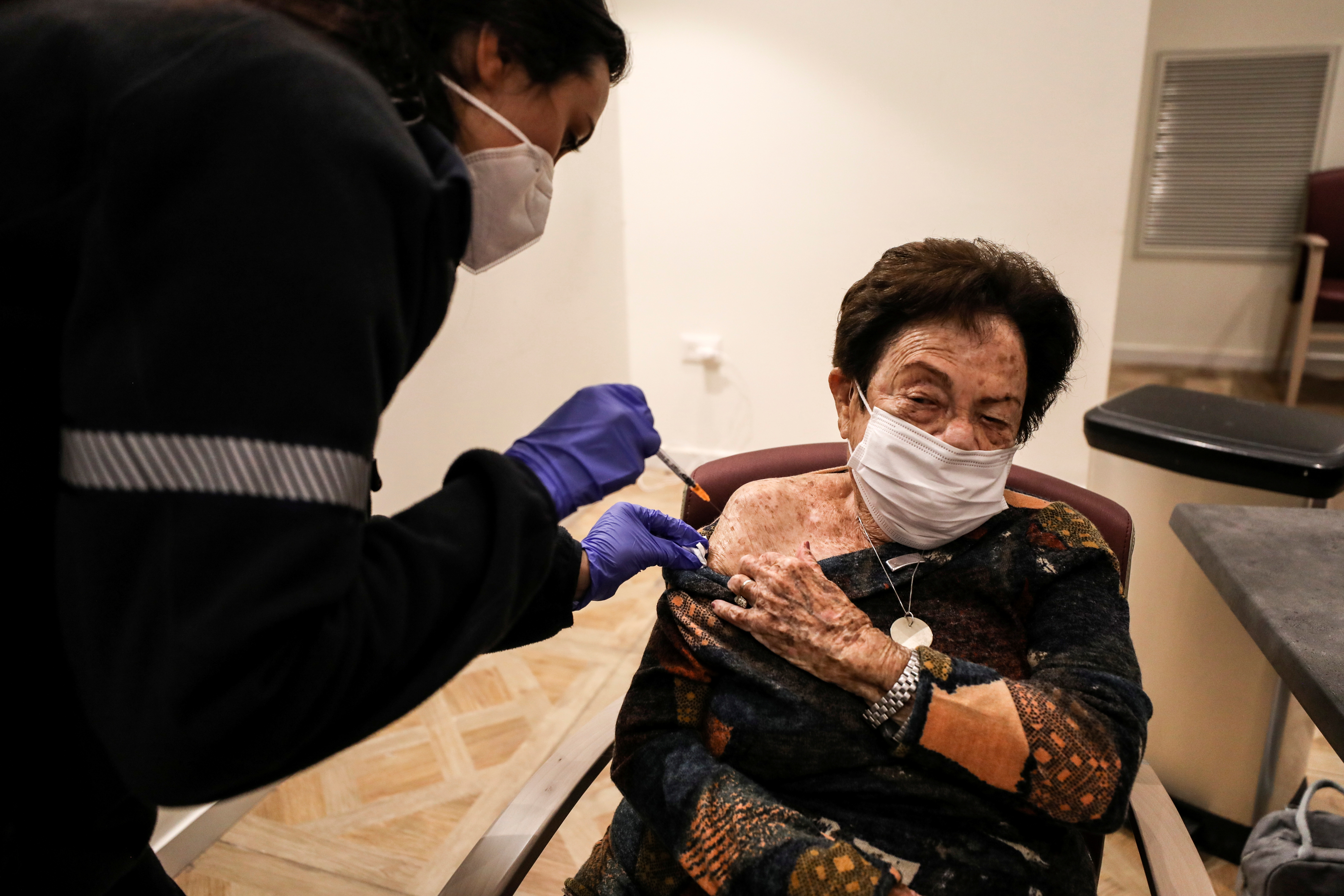 Senior citizens receive a fourth dose of the COVID-19 vaccine at a vaccination party in Netanya