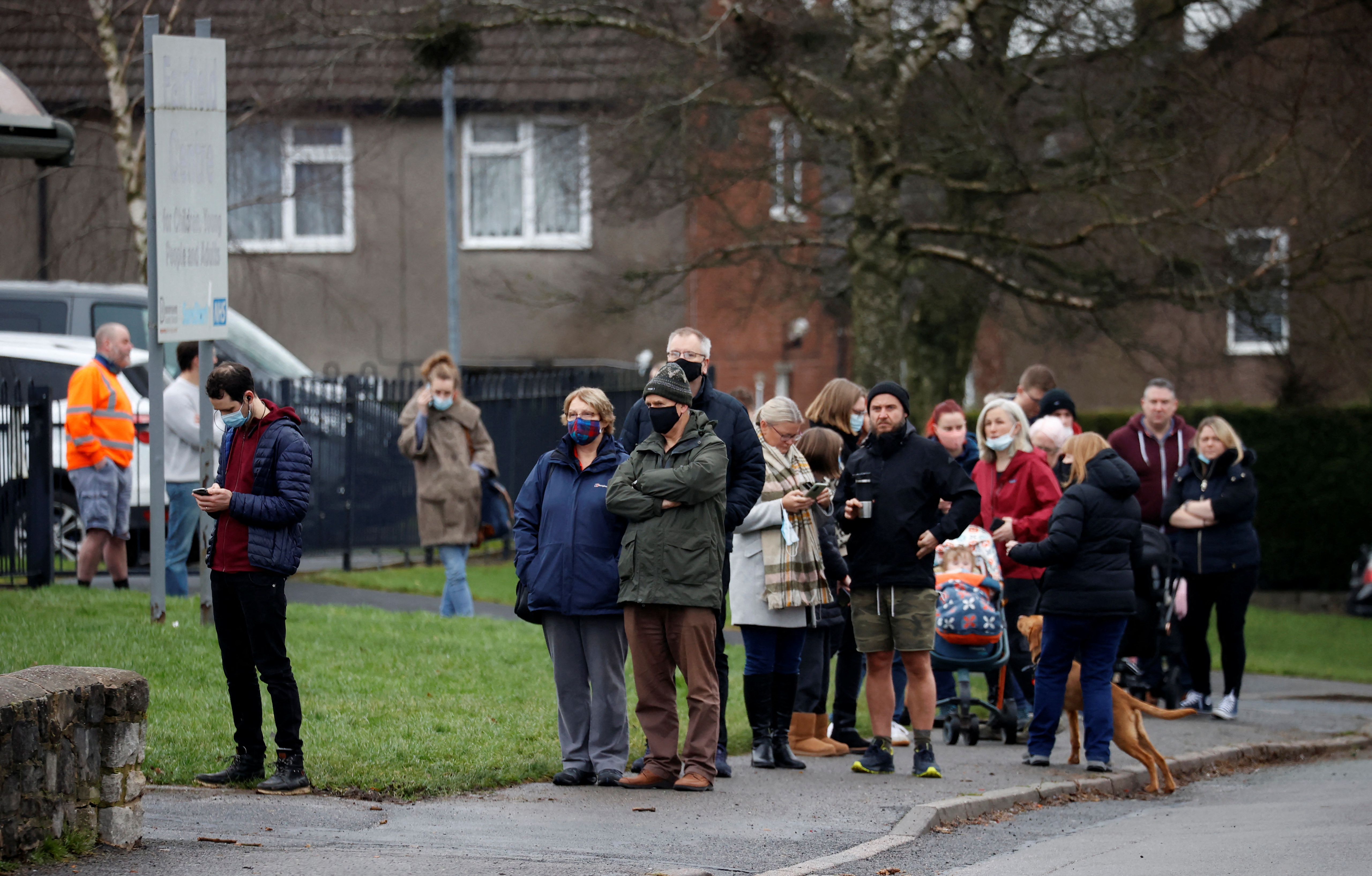 People queue for their booster doses outside the coronavirus disease (COVID-19) vaccination centre in Buxton
