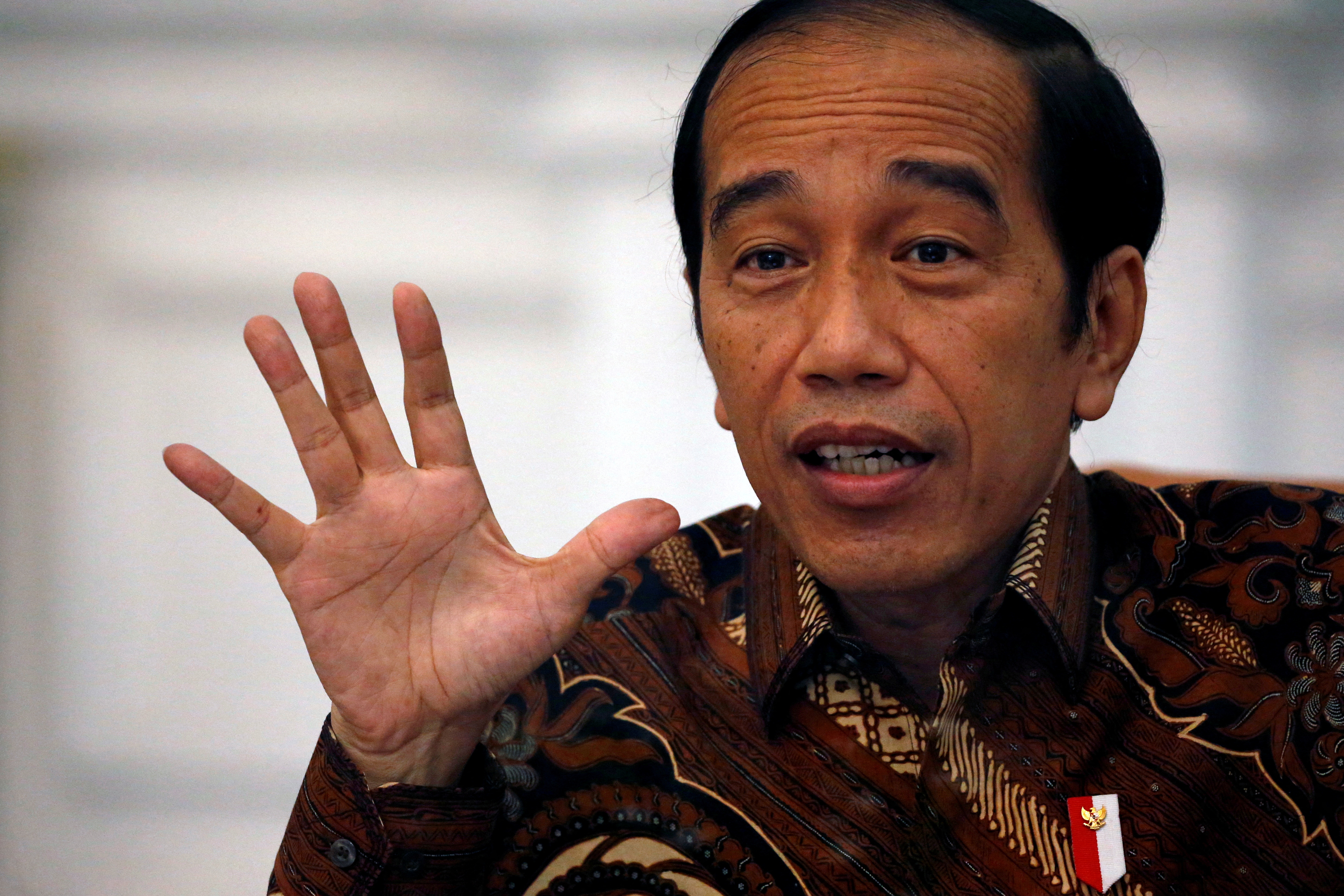 Indonesian President Joko Widodo gestures during an interview with Reuters at the presidential palace in Jakarta