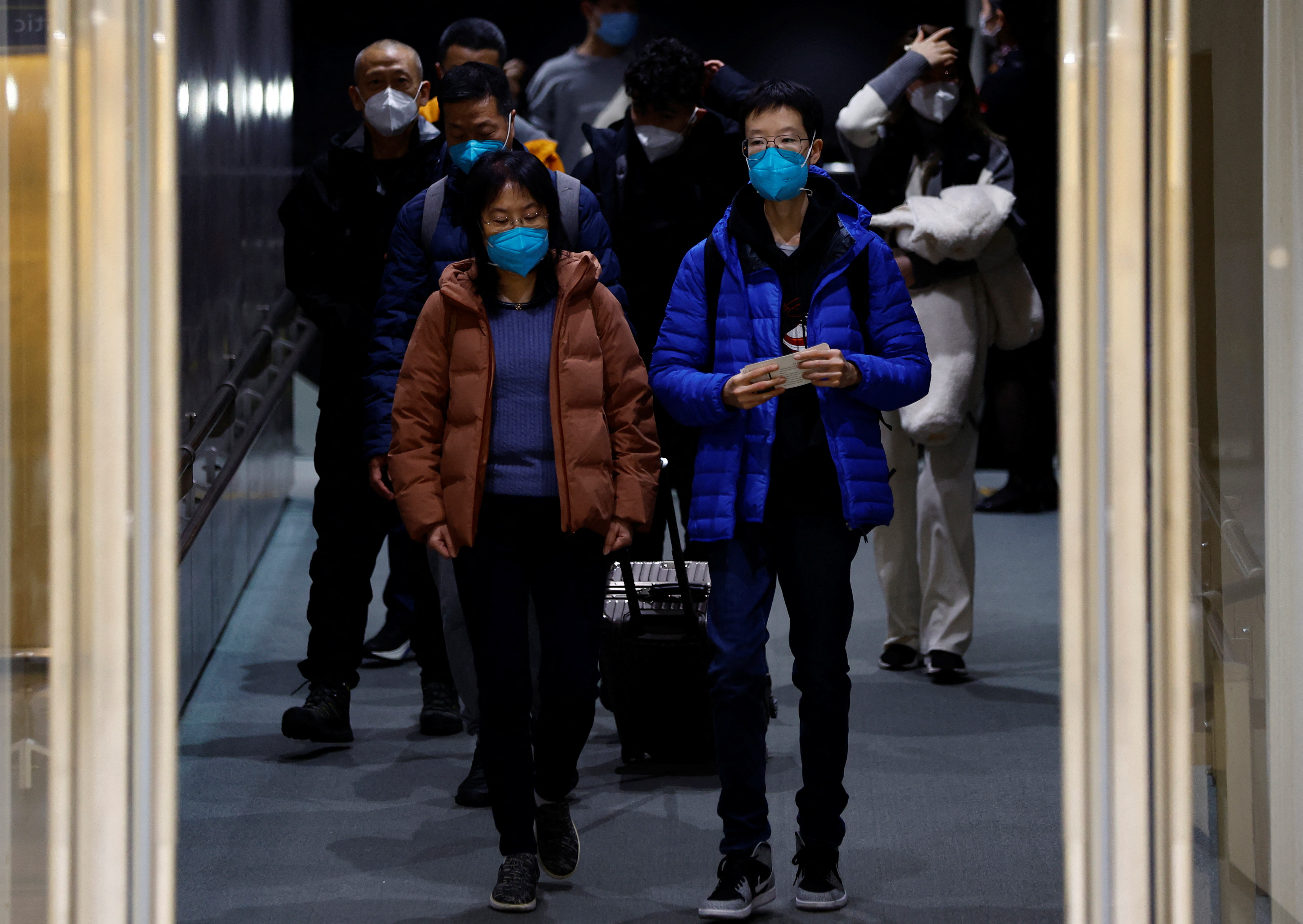 Passengers on a plane from China’s capital Beijing arrive at Narita international airport in Narita