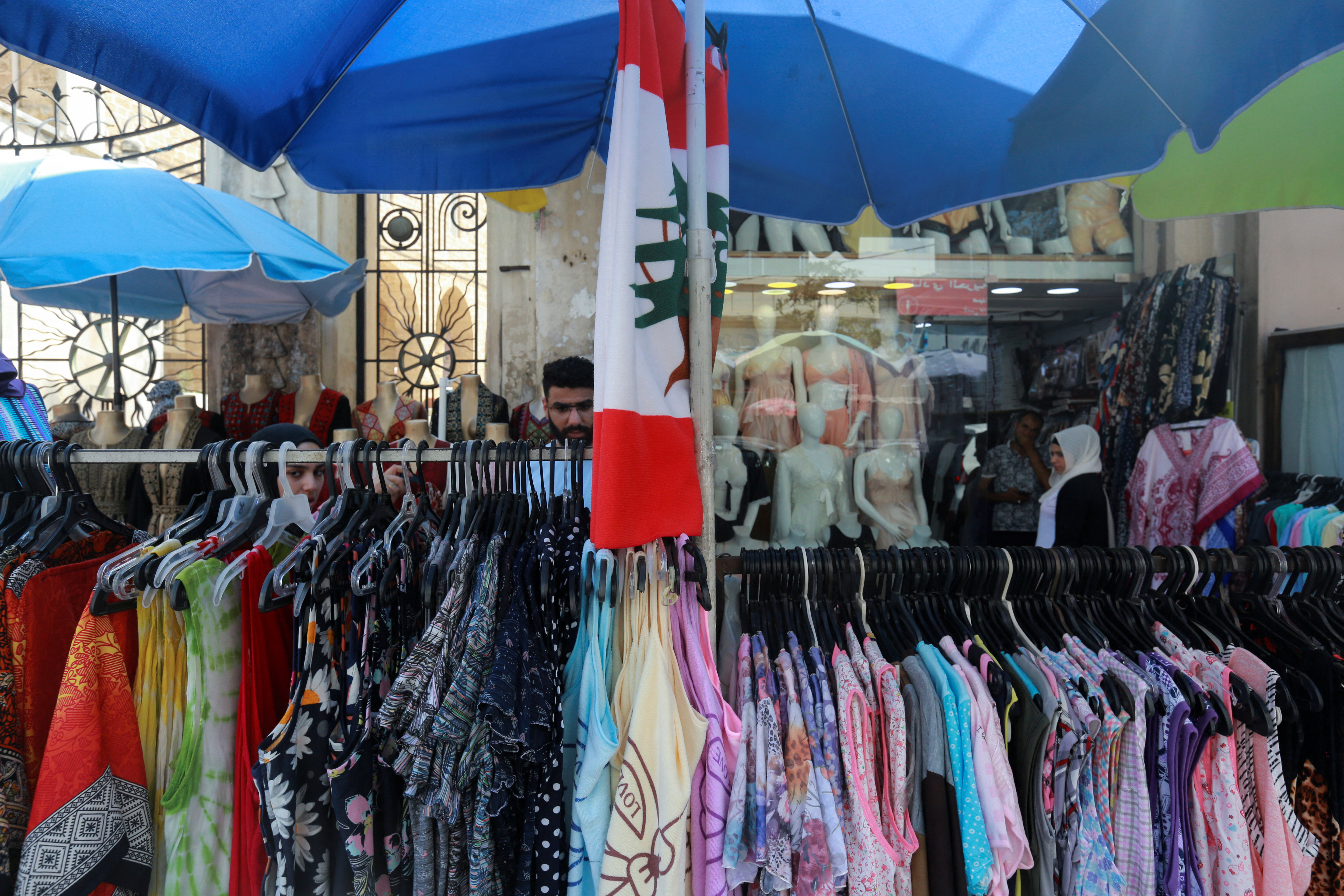 People shop at a market in the southern Lebanese city of Sidon