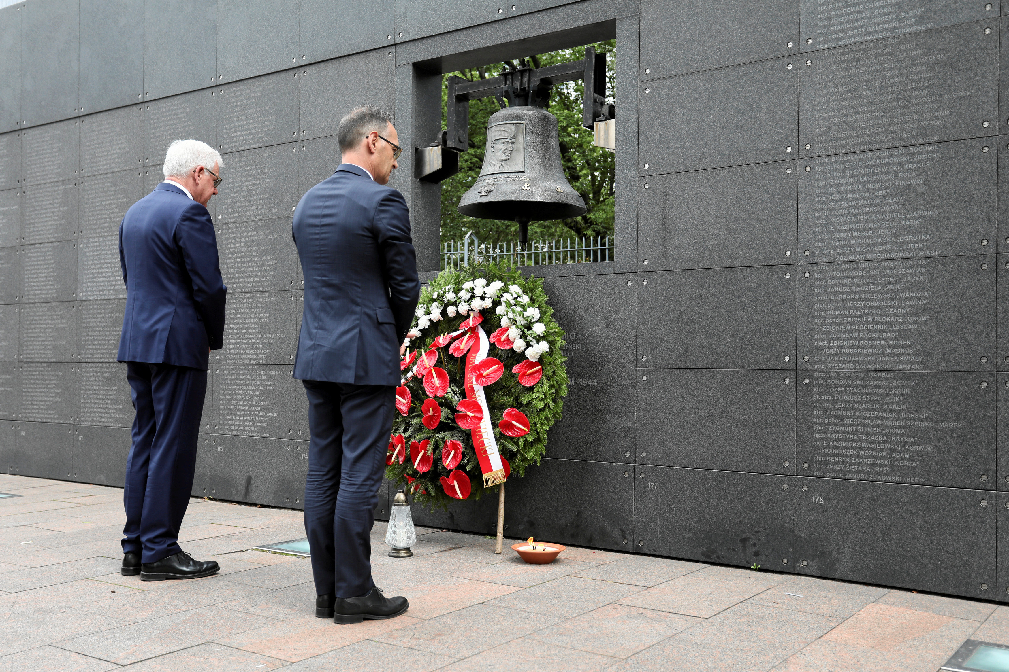 German Foreign Minister Heiko Maas and his Polish counterpart Jacek Czaputowicz pay respect at the Wall of Rememberence as they commemorate the 75th anniversary of Warsaw Uprising at Warsaw Rising Museum in Warsaw