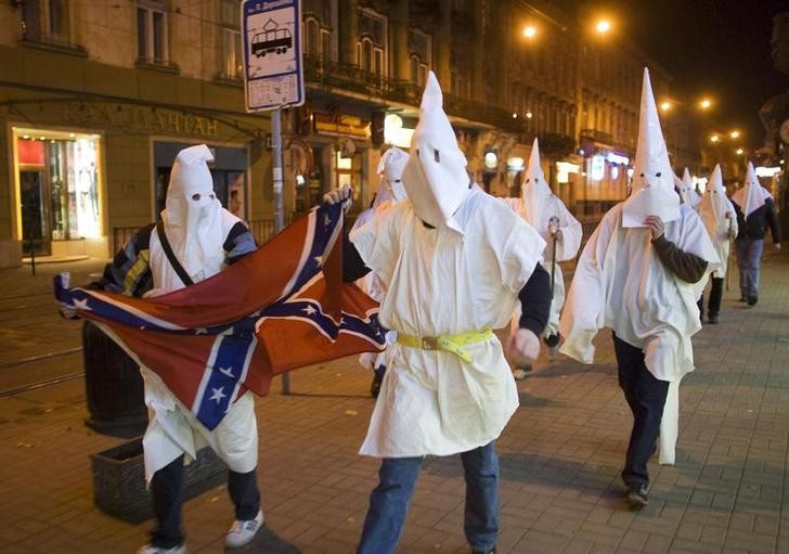 Supporters dressed as members of the Ku Klux Klan express anti-Semitic views in Lviv
