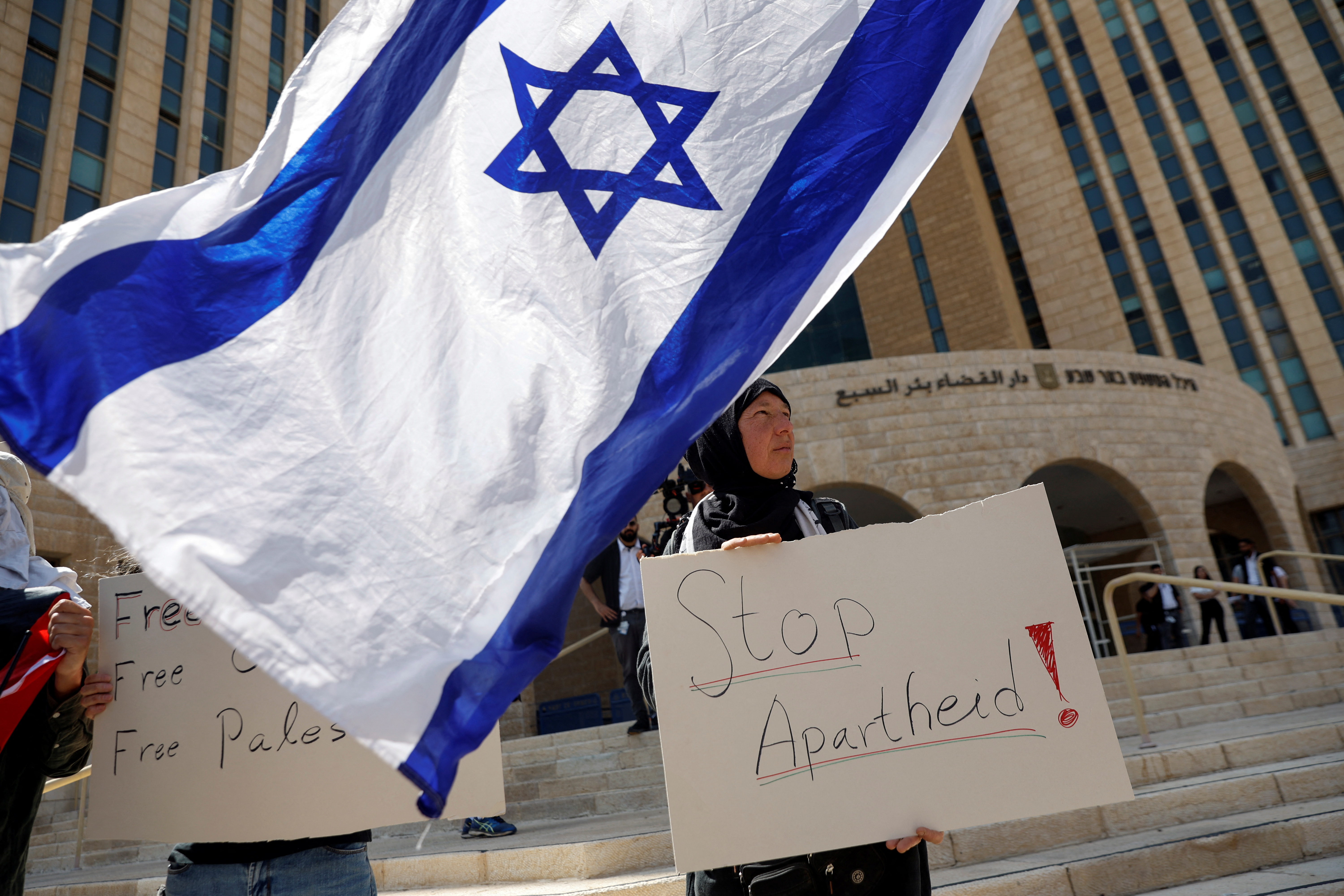A protestor supporting Palestinian Mohammad El Halabi, stands outside an Israeli court in Beersheba, Israel