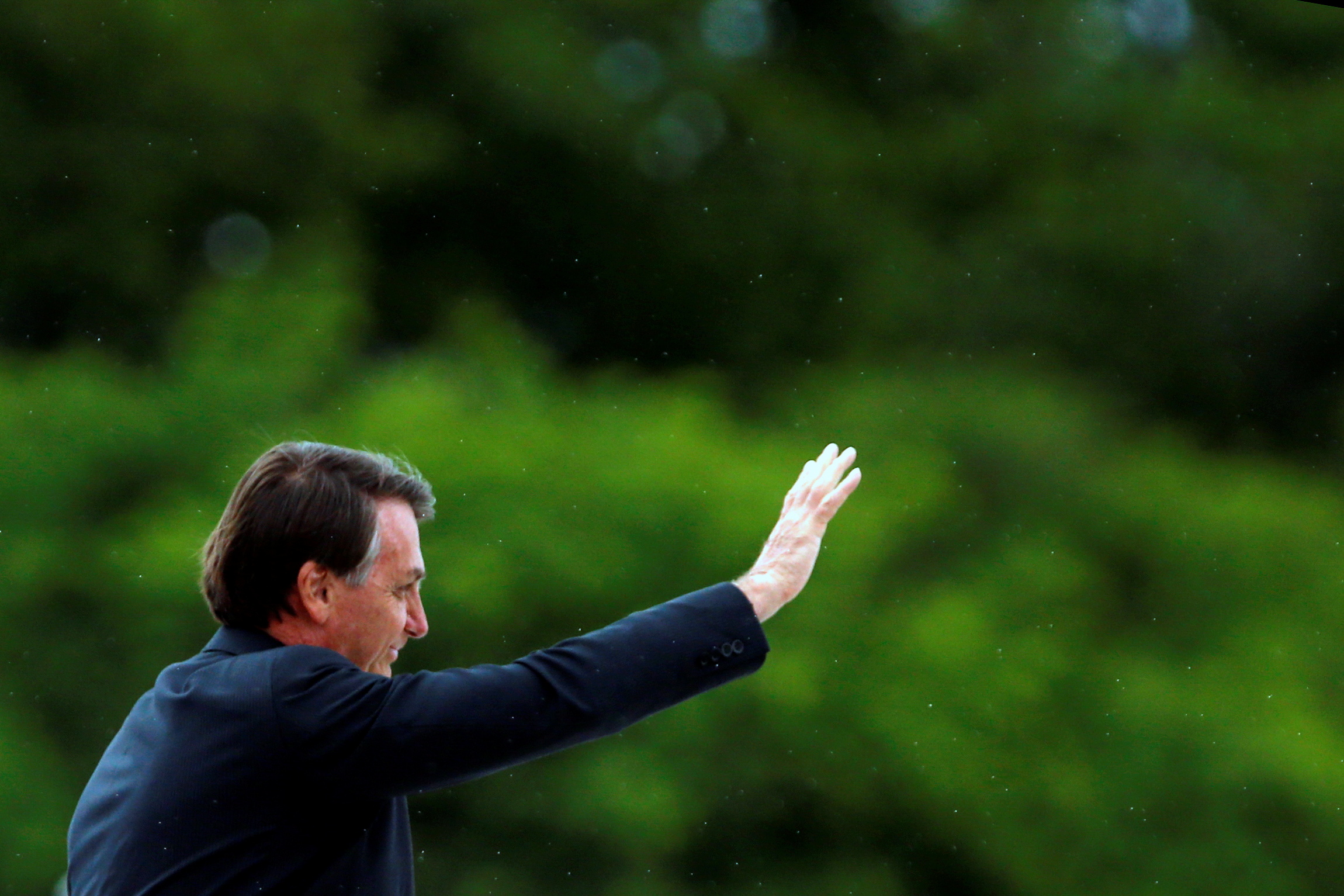 Brazil's President Jair Bolsonaro gestures before a Flag Day ceremony in Brasilia