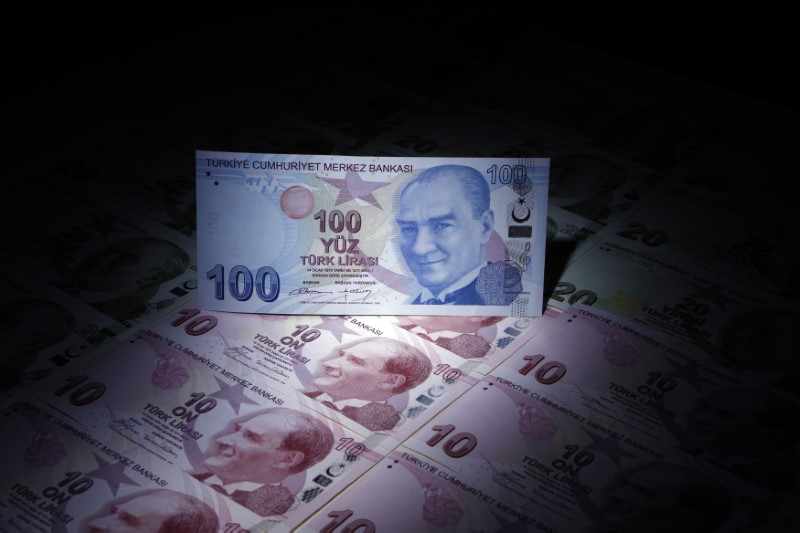 A Turkish 100 lira banknote is seen on top of 10 lira banknotes in this illustration picture taken in Istanbul January 28, 2014. Turkey's central bank governor raises hopes of emergency rate hike in face of opposition from Prime Minister Tayyip Erdogan, denying he is hostage to political pressures and vowing to fight rising inflation and tumbling lira. REUTERS/Murad Sezer 