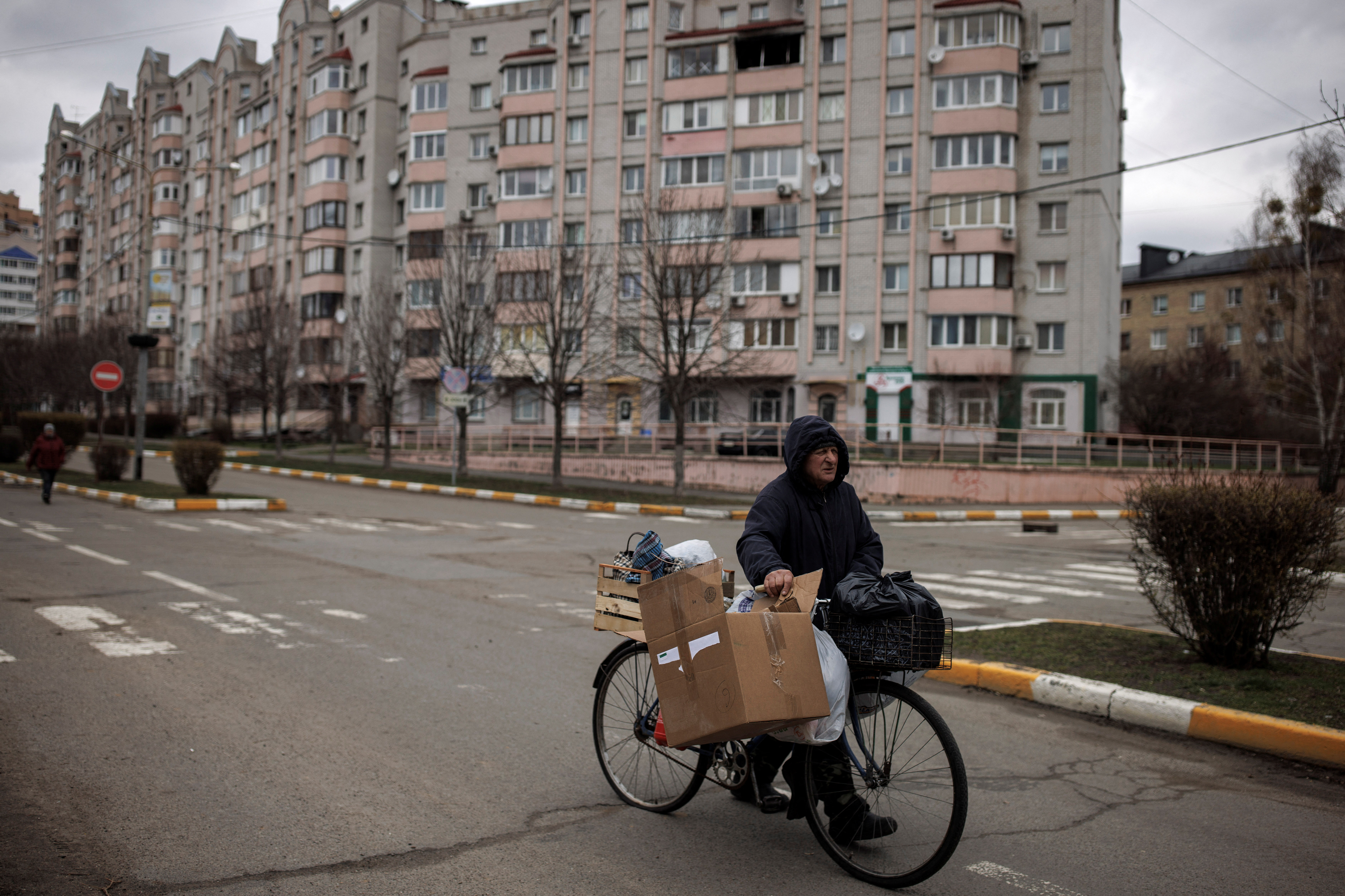 Man pushes his bicycle, amid Russia's invasion on Ukraine, in Bucha