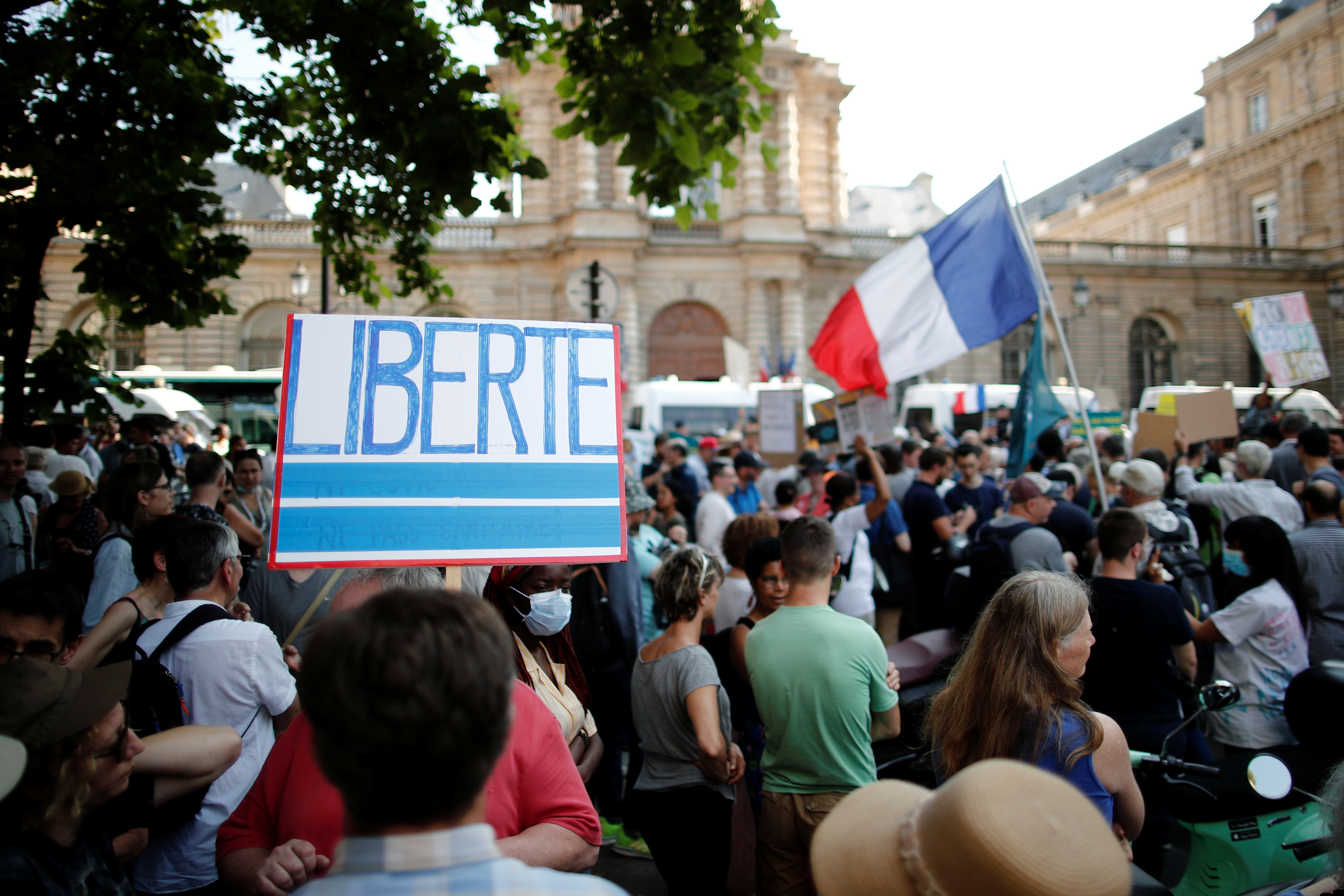 A placard reads "Freedom" during a demonstration called by the Popular Republican Union (UPR) against the new coronavirus safety measures including a compulsory health pass in front of the French Senate in Paris, France, July 22, 2021. REUTERS/Benoit Tessier