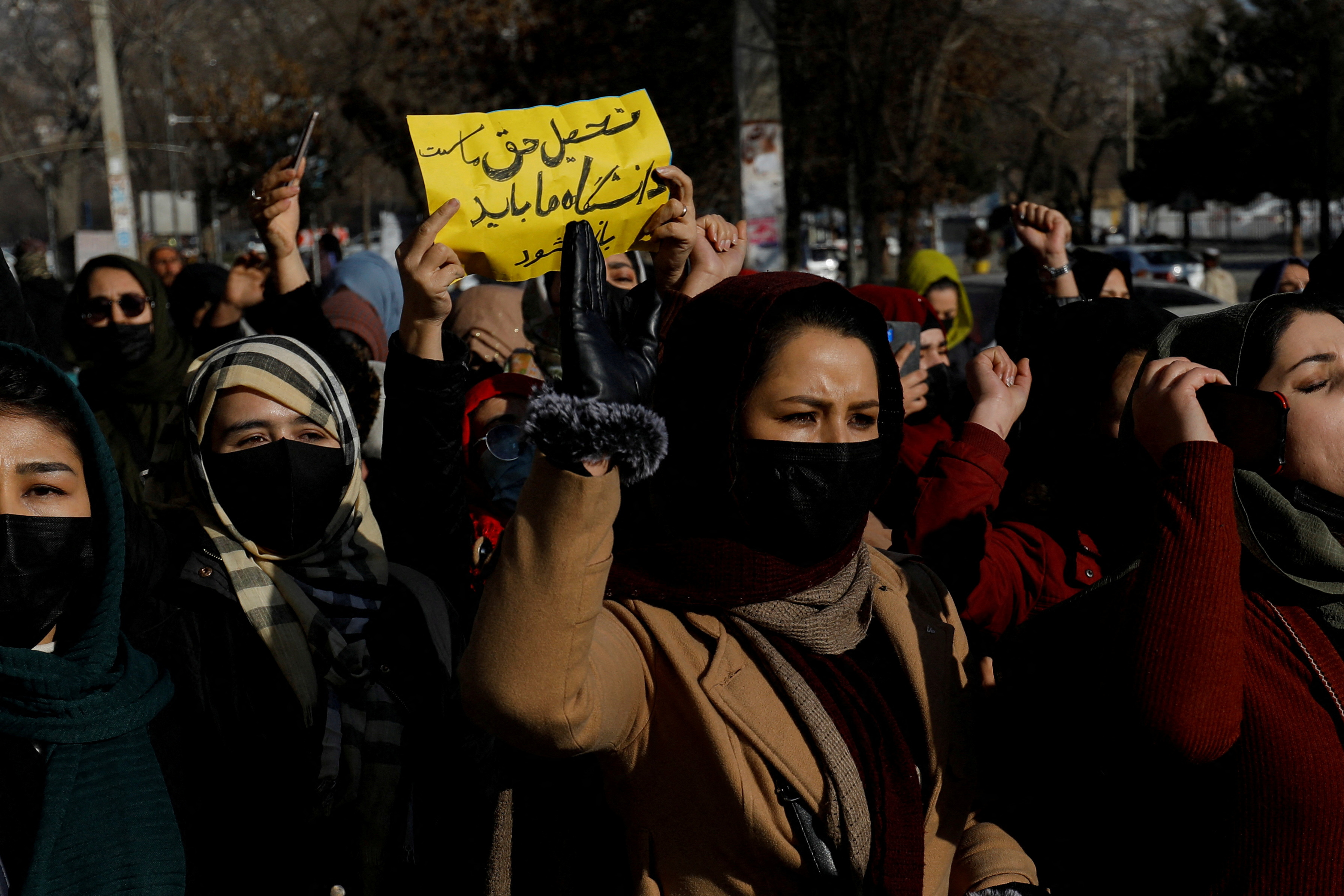 Afghan women chant slogans in protest against the closure of universities to women by the Taliban in Kabul