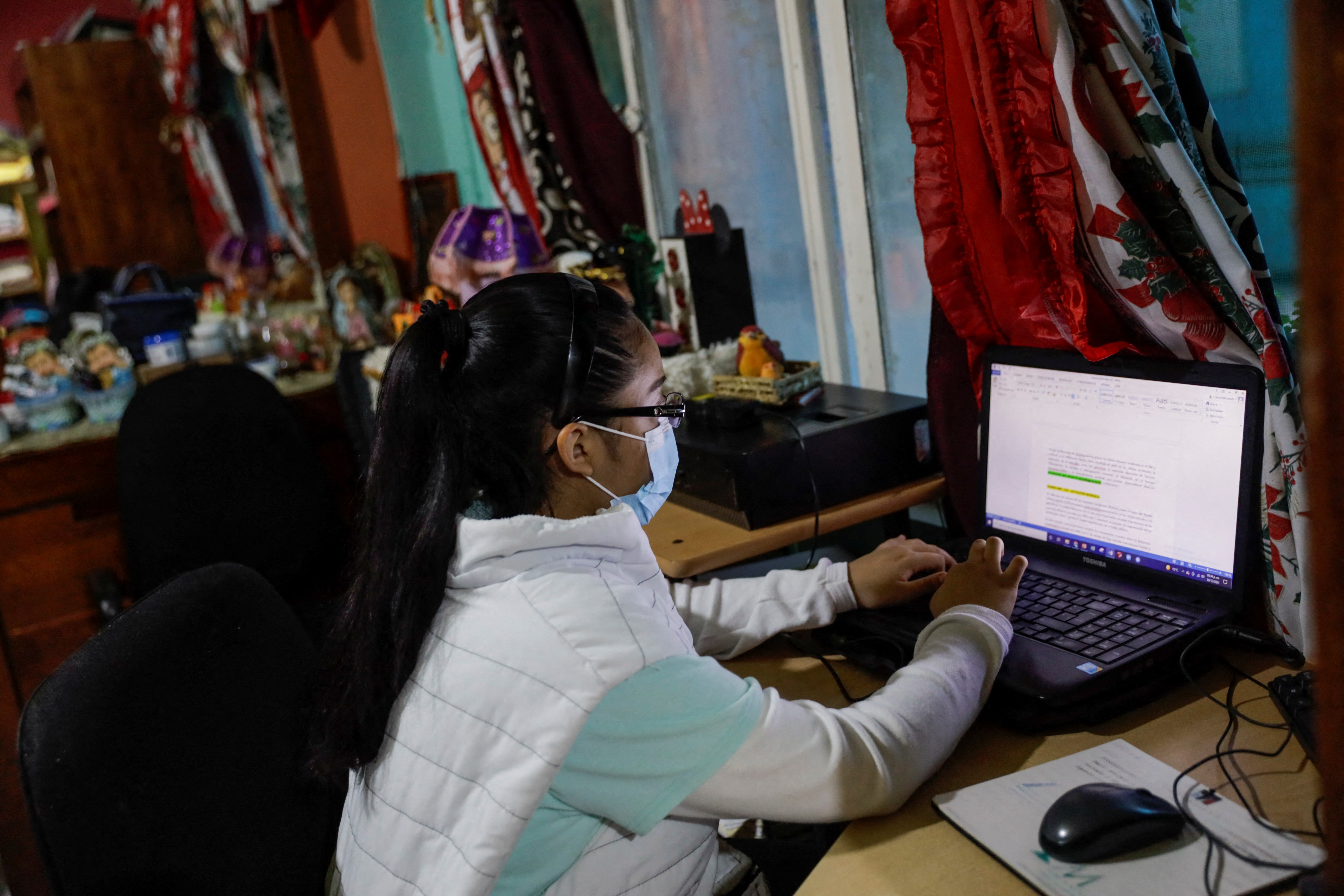 Guadalupe Estrella Salazar Calderon, 17, who is developing a sign-language translation app to connect Mexican Sign Language (MSL) speakers and interpreters with hearing users, writes a document in her laptop, at her house in the municipality of Nezahualcoyotl, Mexico December 30, 2021. REUTERS/Luis Cortes