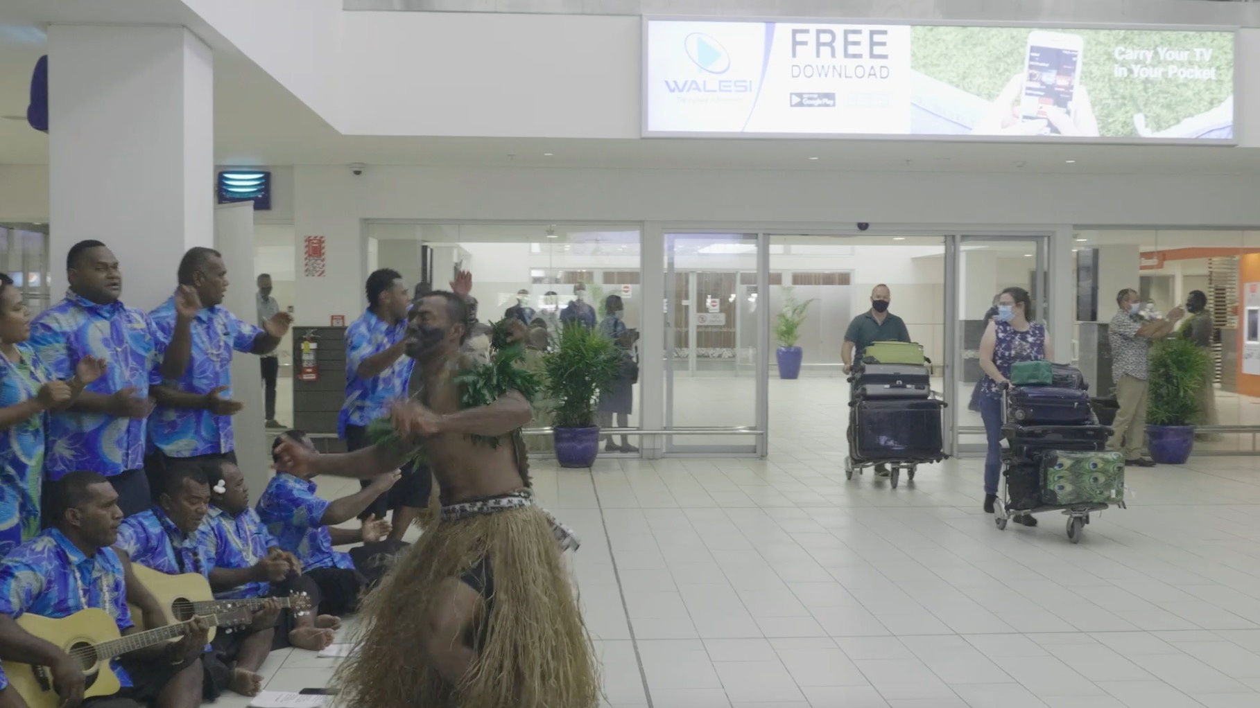 Performers greet travellers in the terminal upon arrival at Nadi Airport, Fiji in this still frame obtained from handout video dated December 1, 2021