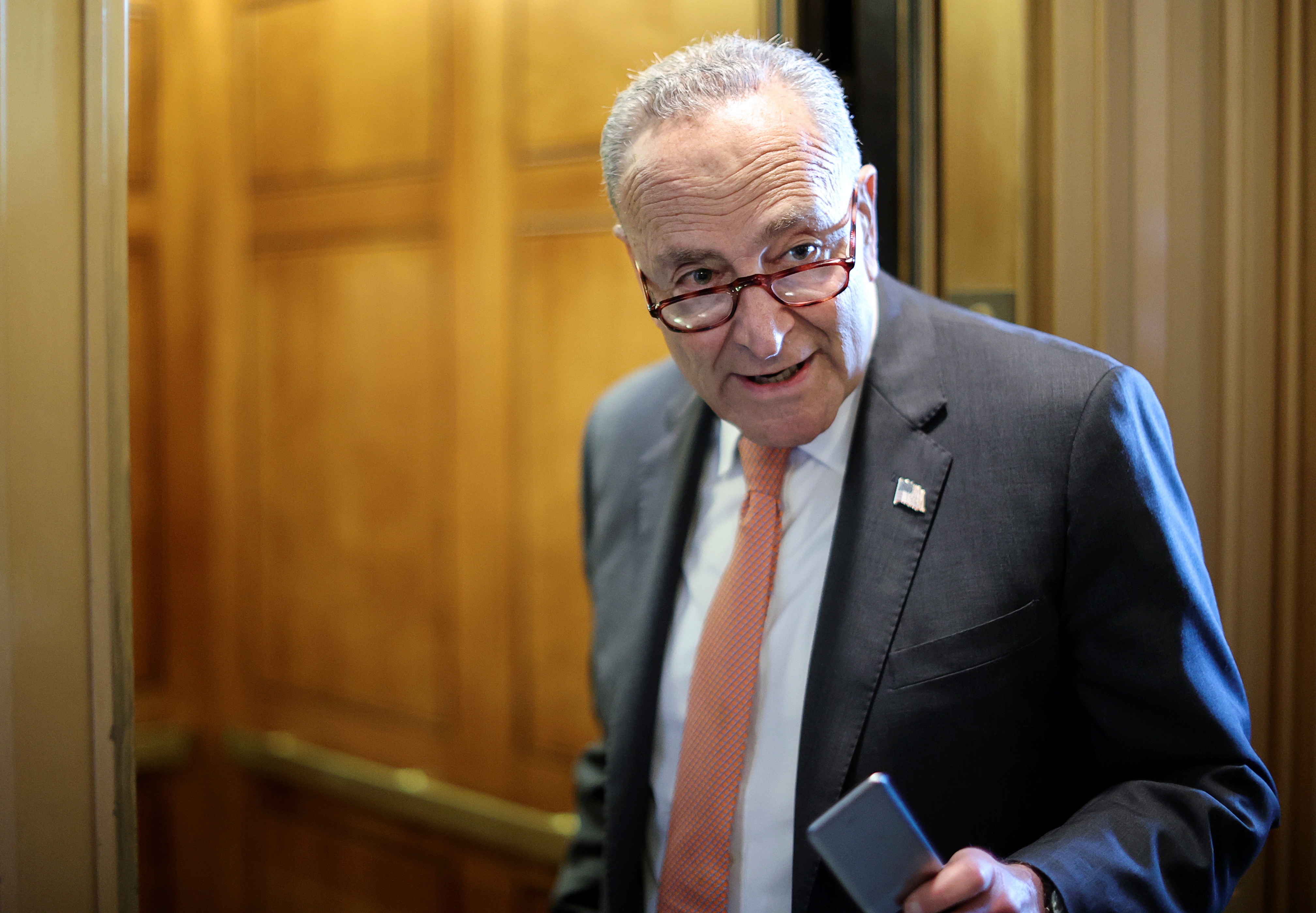 U.S. Senate Majority Leader Chuck Schumer (D-NY) speaks to a reporter about the status of a deal on infrastructure legislation as he departs the Senate floor at the U.S. Capitol in Washington, U.S., June 8, 2021. REUTERS/Jonathan Ernst