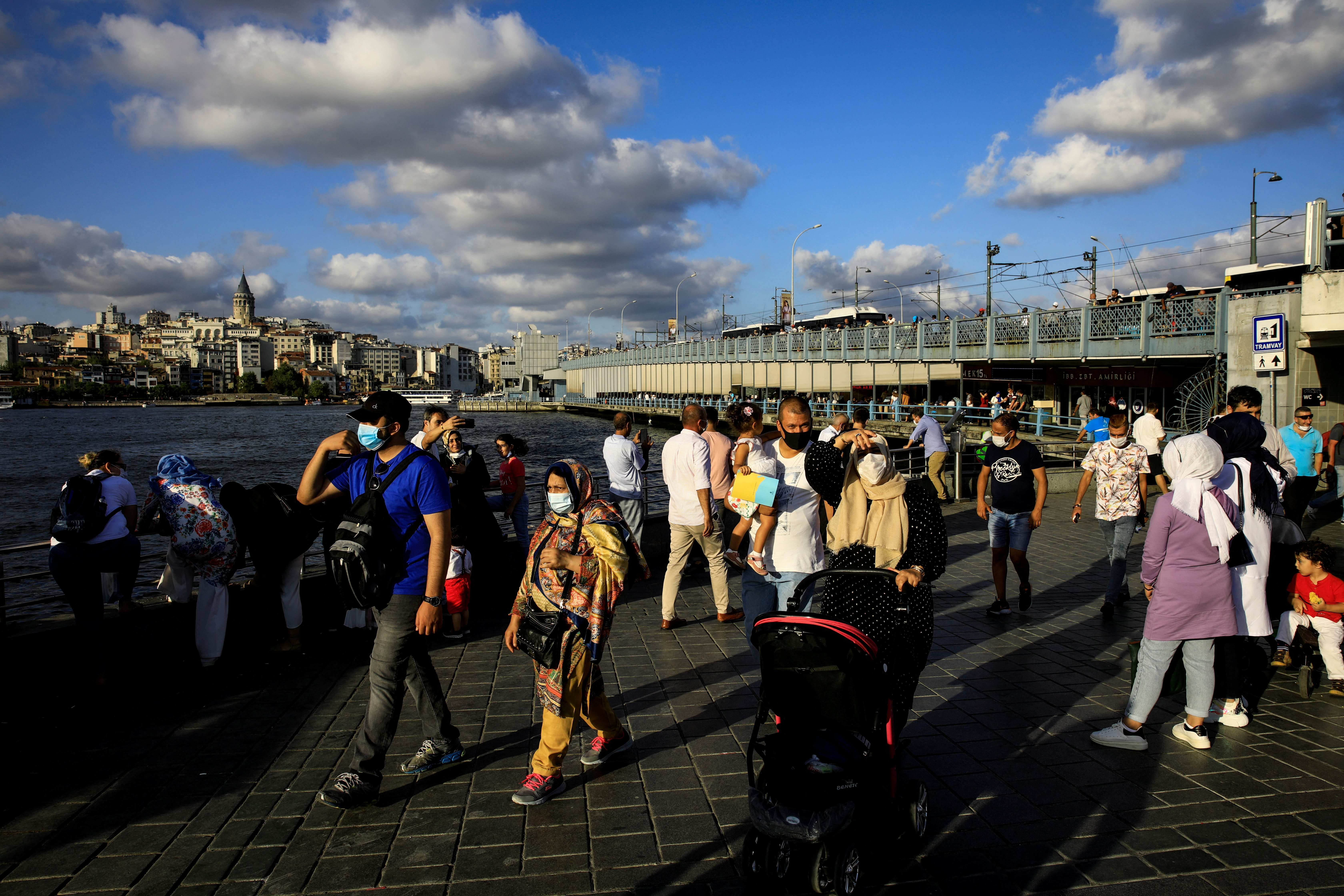 Commuters walk through Eminonu pier in Istanbul