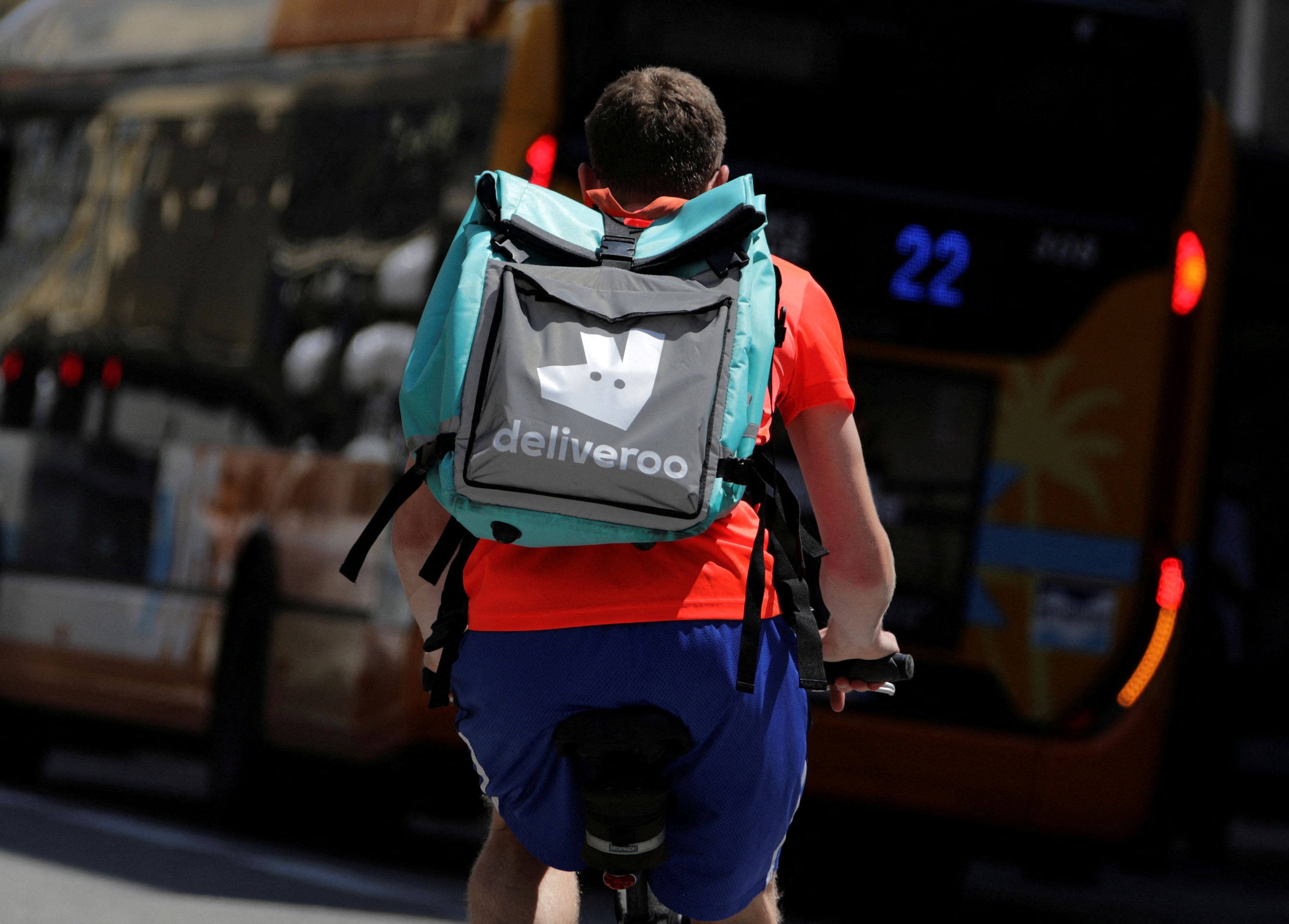 A food delivery cyclist carries a Deliveroo bag in Nice