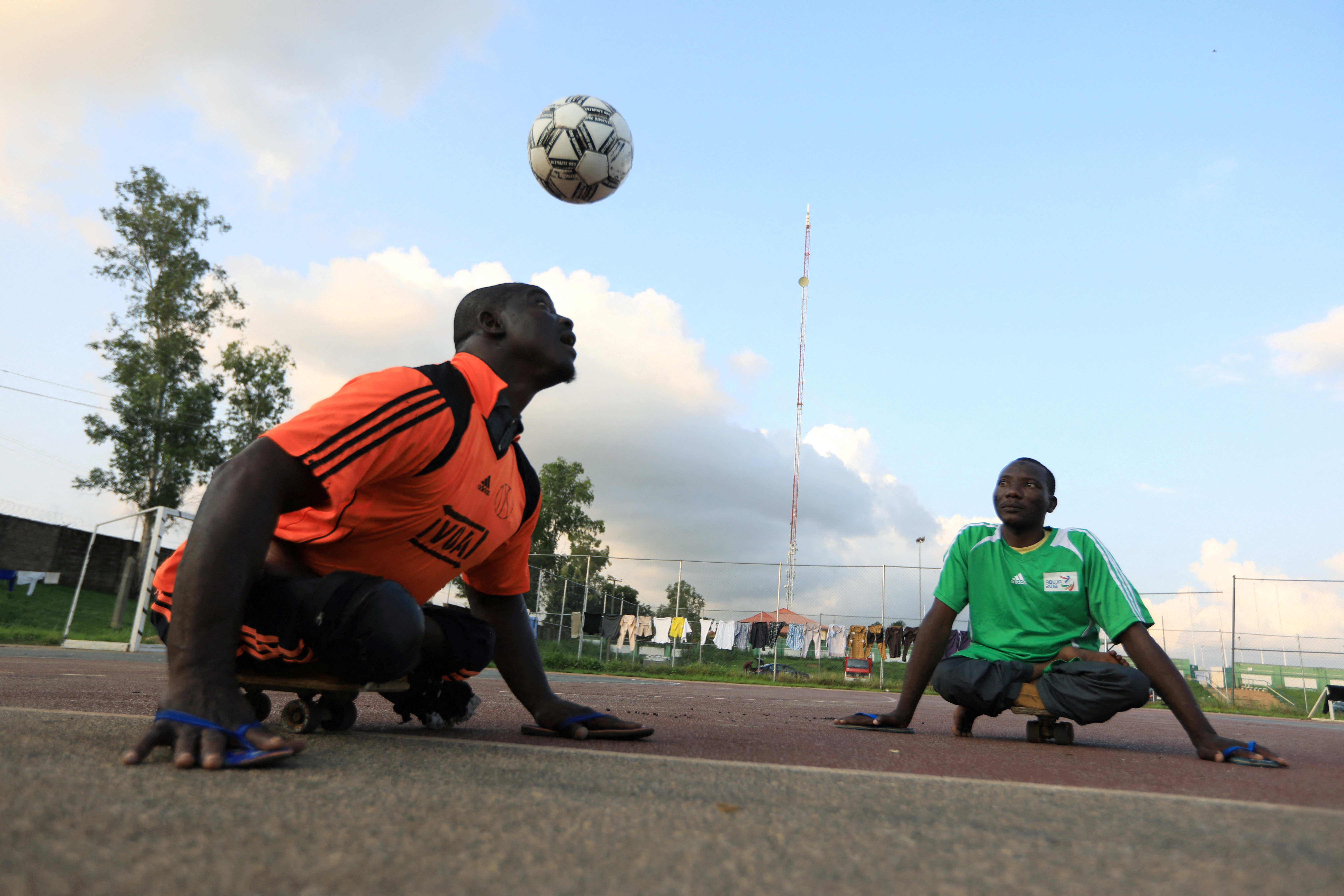 A victim of polio disease heads the ball during a game of para-soccer in Abuja