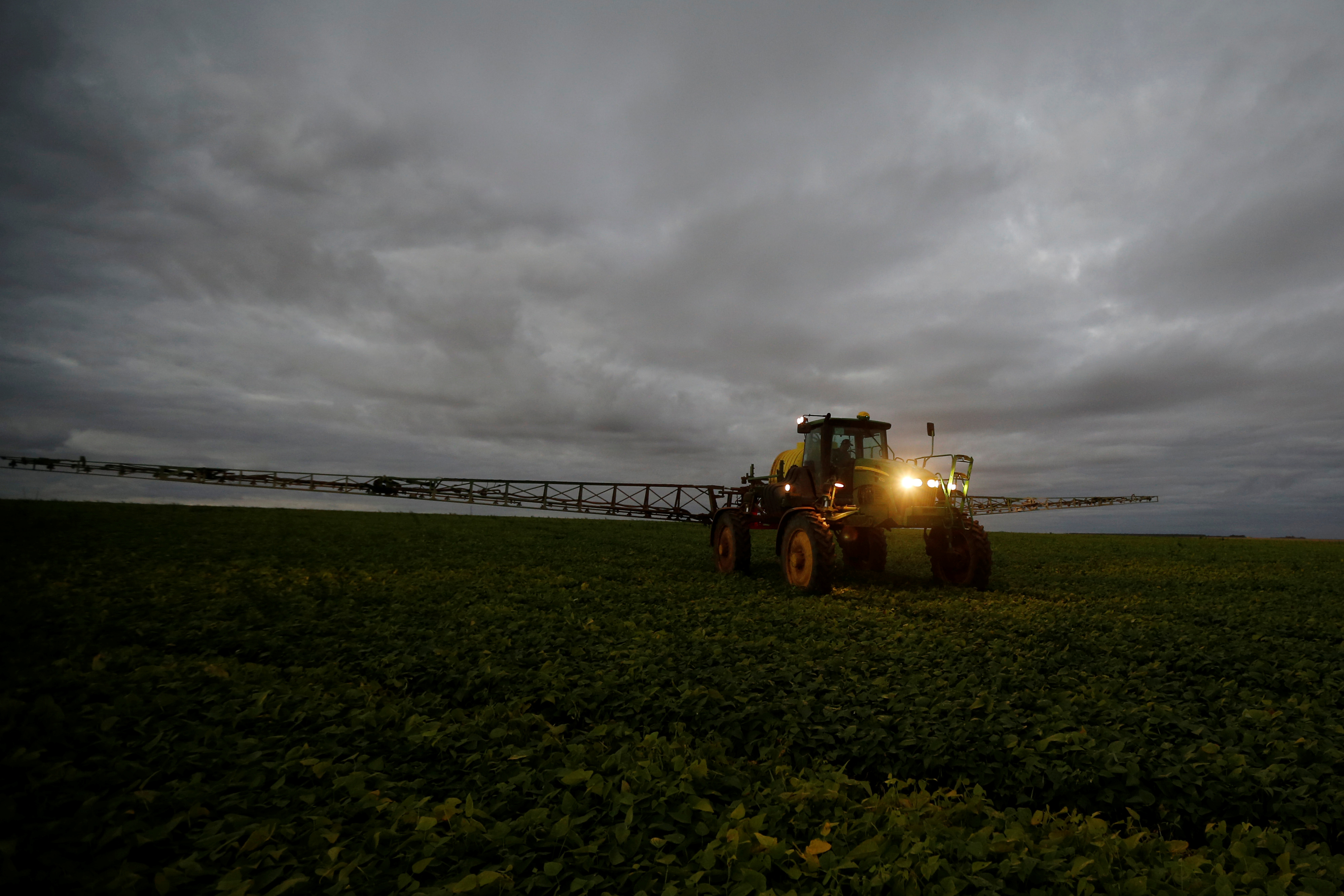 A farmer works with his tractor on a field near Brasilia