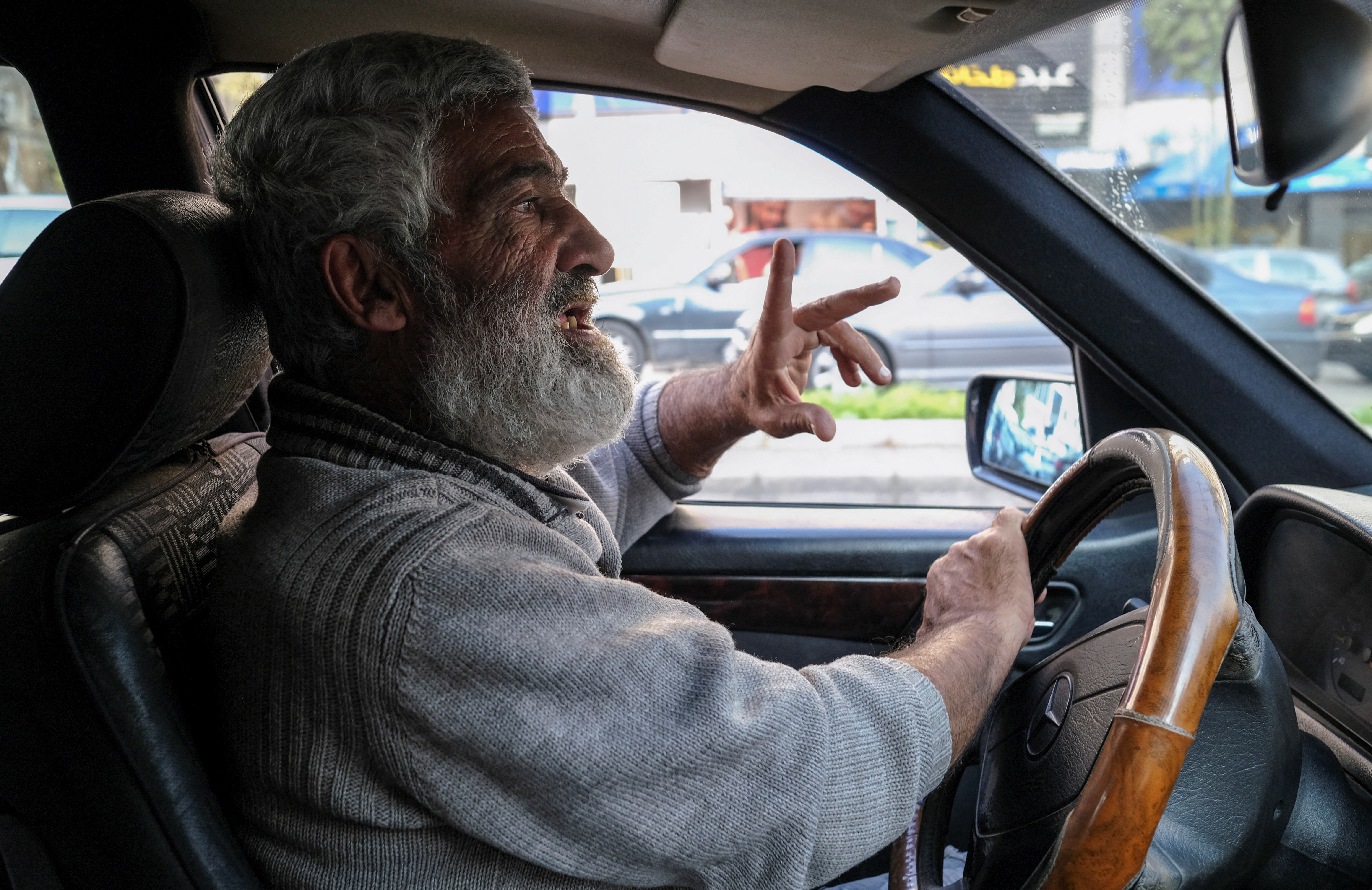 Cab driver Abed Omayraat, talks during an interview with Reuters as he drives his cab in Beirut
