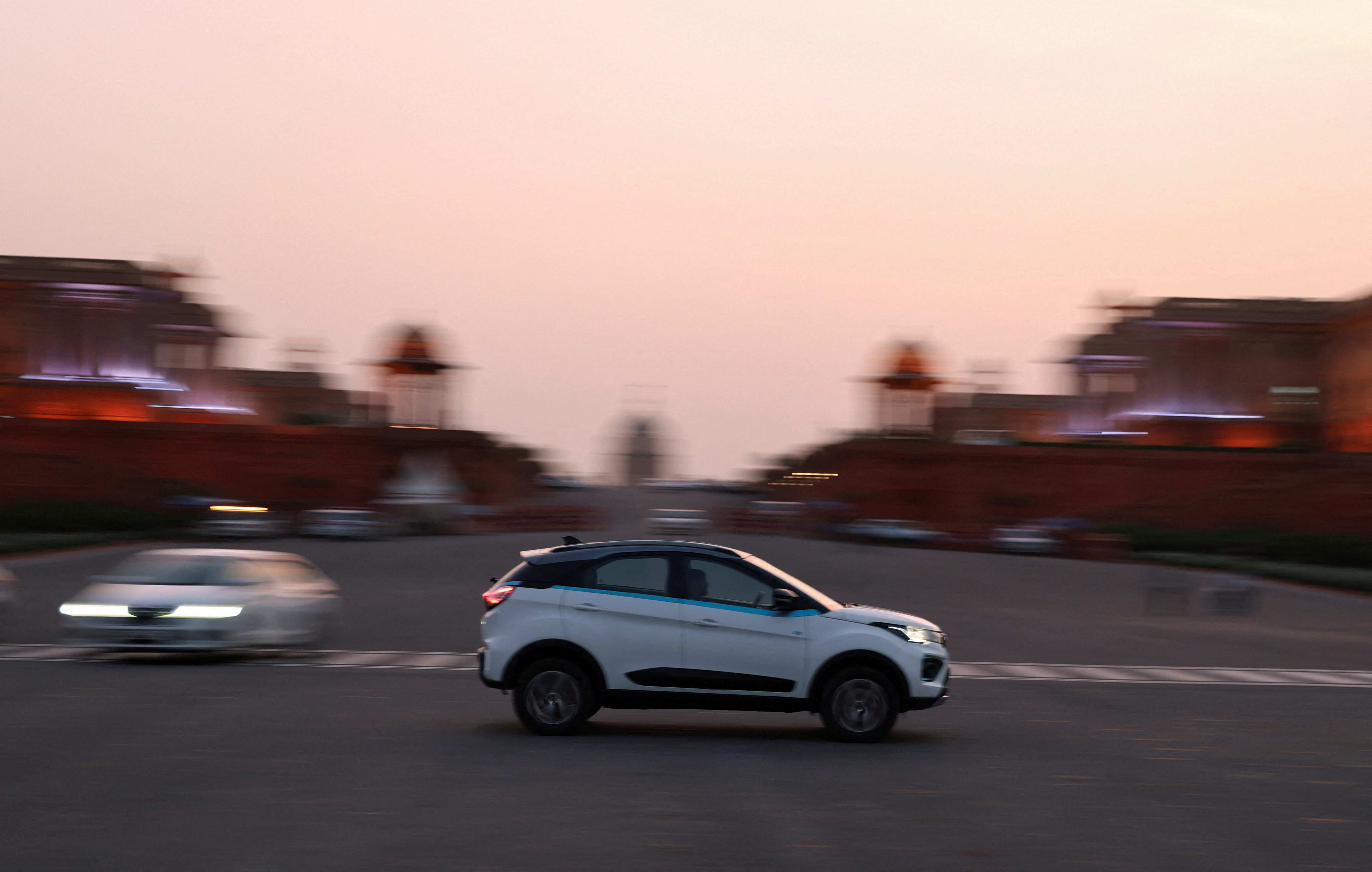 An electric vehicle is driven on the road near India's Rashtrapati Bhavan Presidential Palace in New Delhi