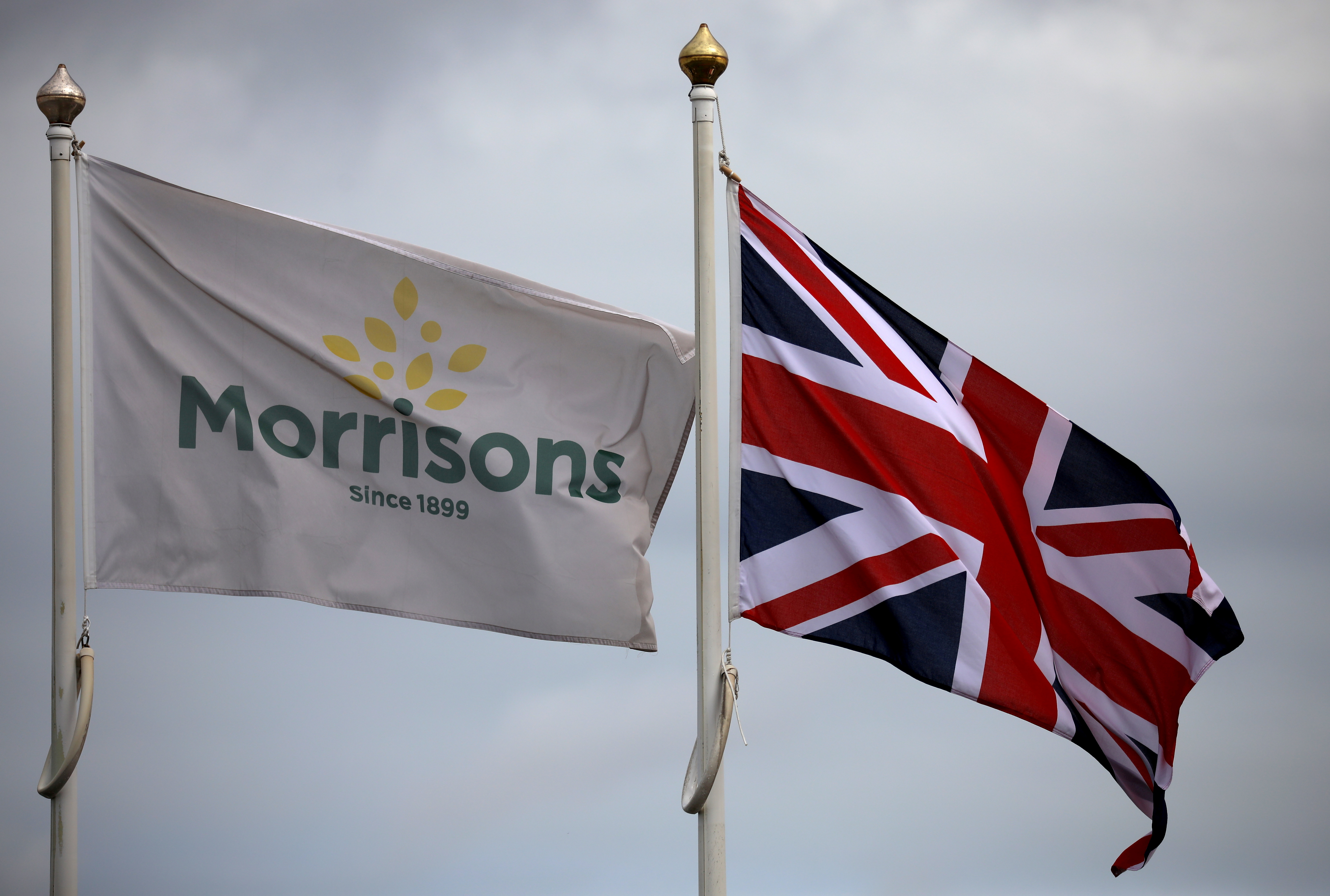 Flags fly outside a Morrisons supermarket in New Brighton, Britain, July 5, 2021. REUTERS/Phil Noble/File Photo
