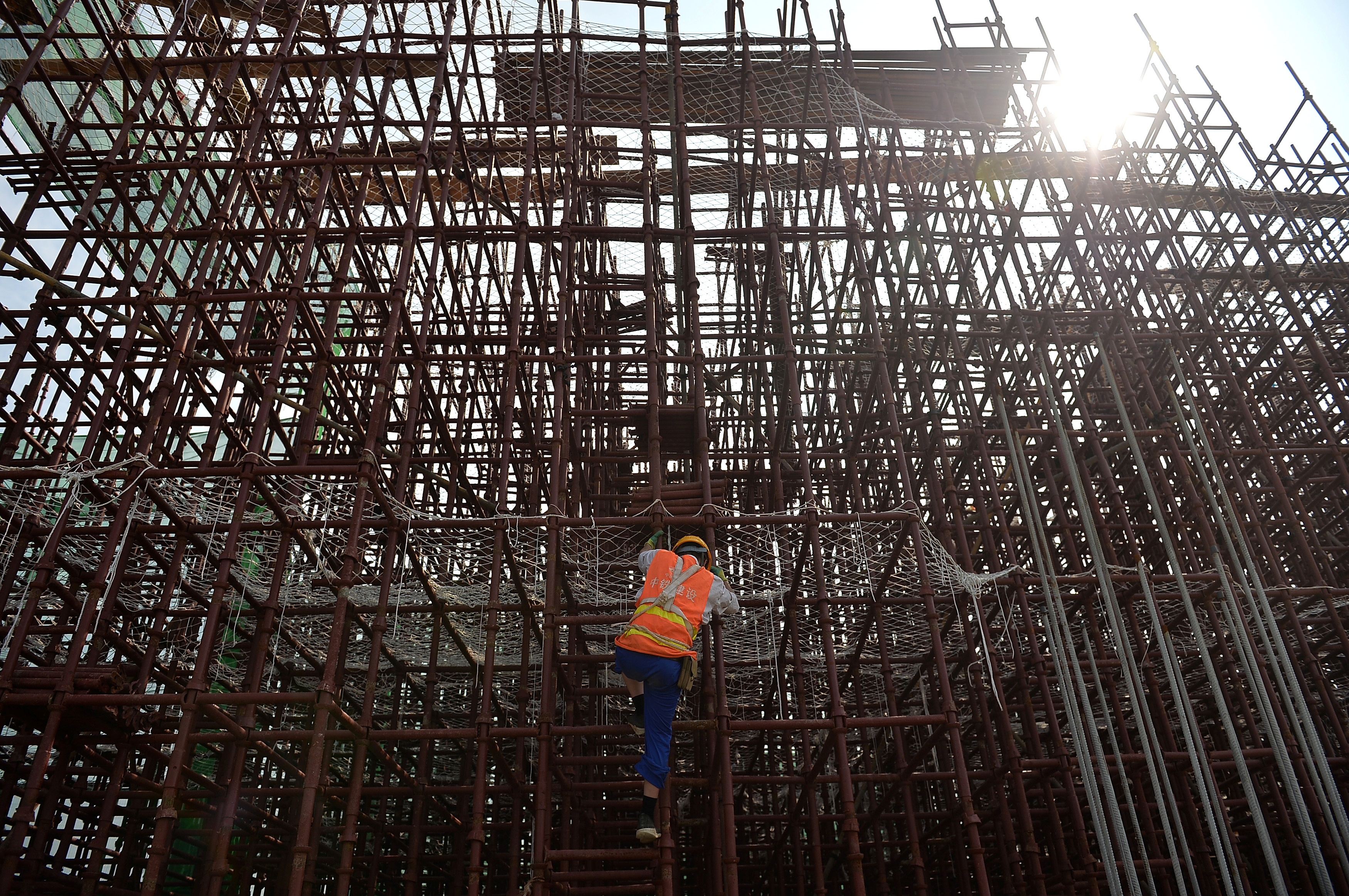 Worker climbs on steel bars at a construction site of a subway in Chengdu, Sichuan