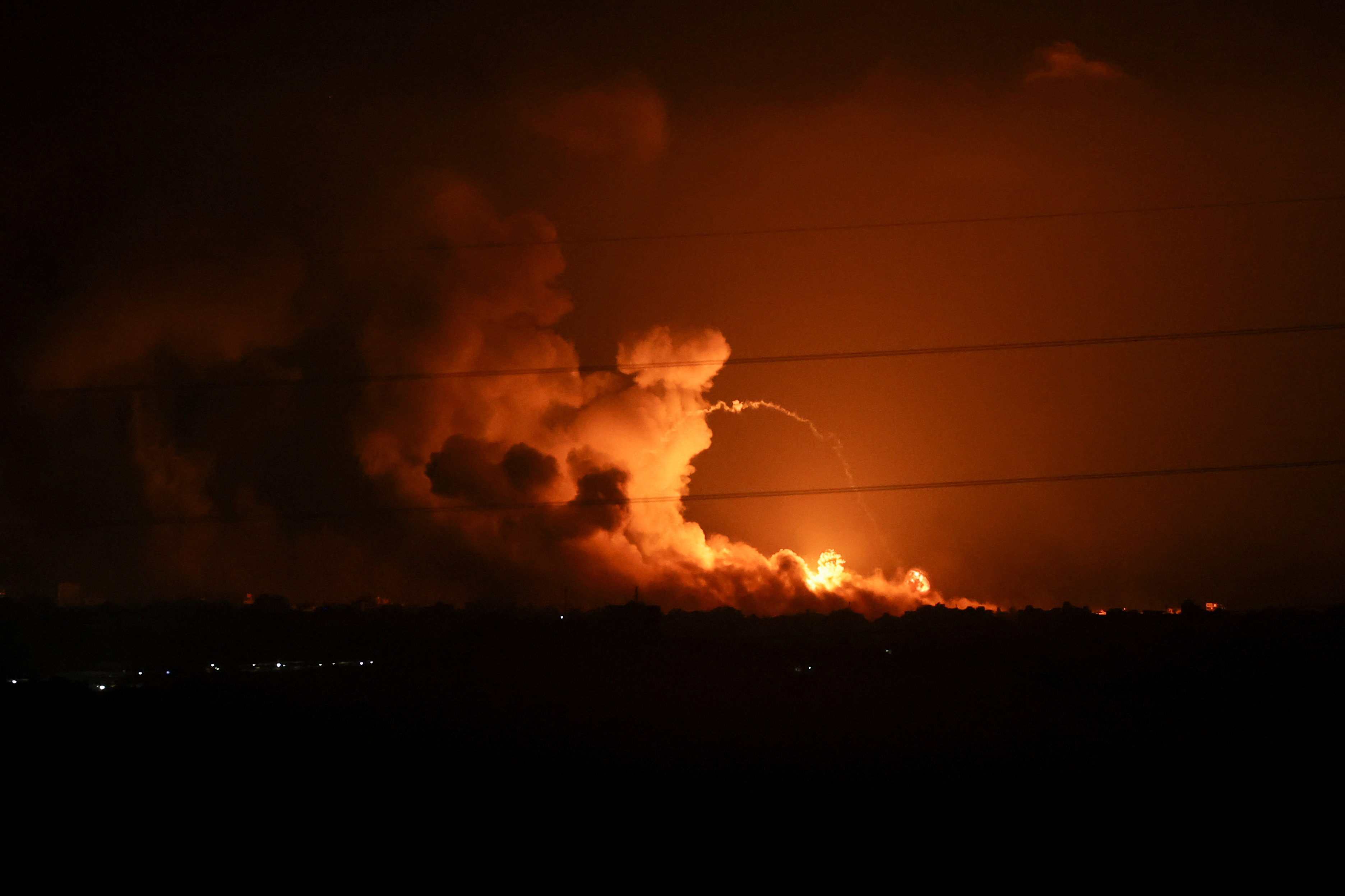 Smoke and flames rise during Israeli strikes in the Gaza Strip, as seen from the Israeli side of the border with Gaza