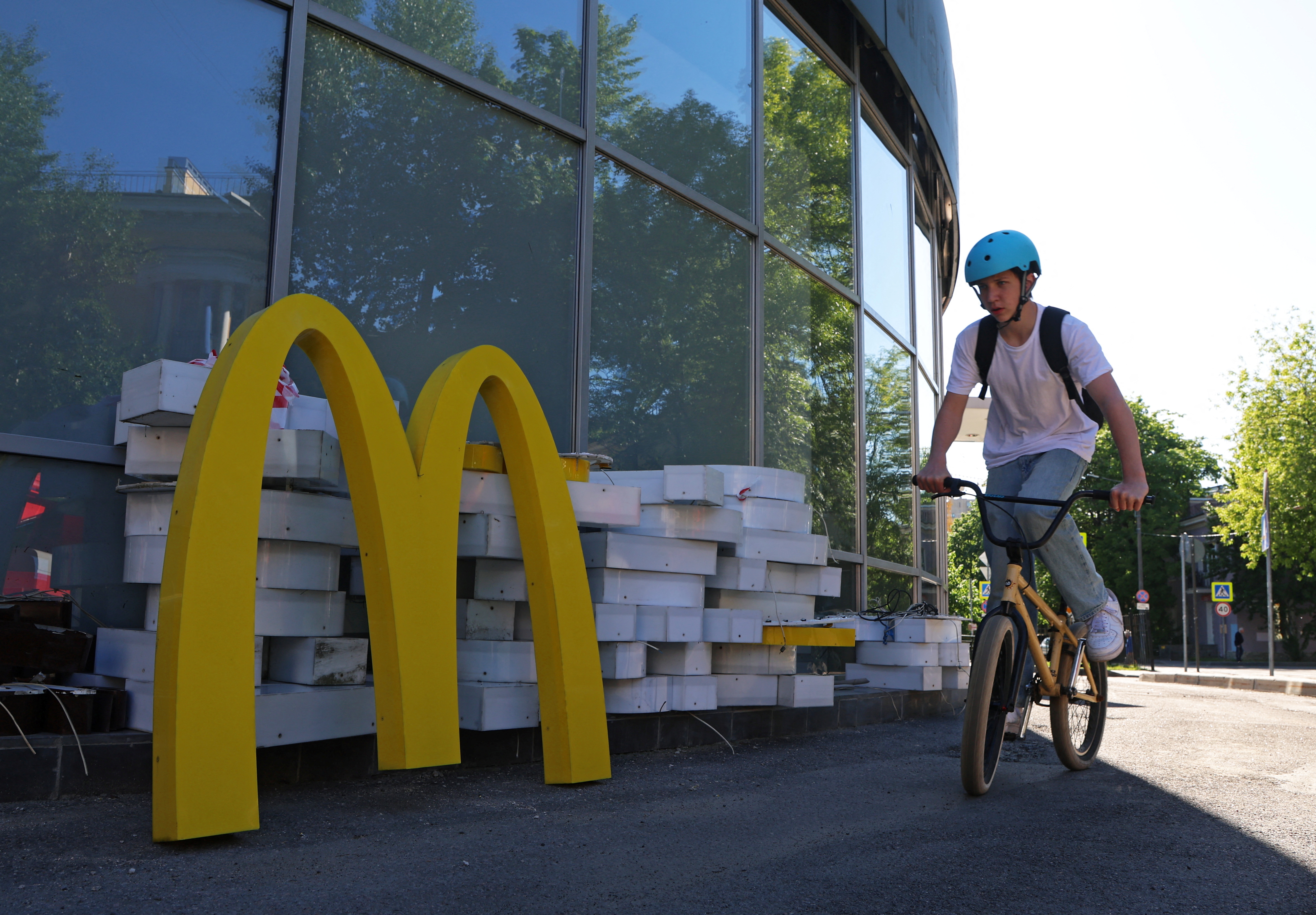 Workers dismantle a McDonald's sign from a restaurant in Saint Petersburg