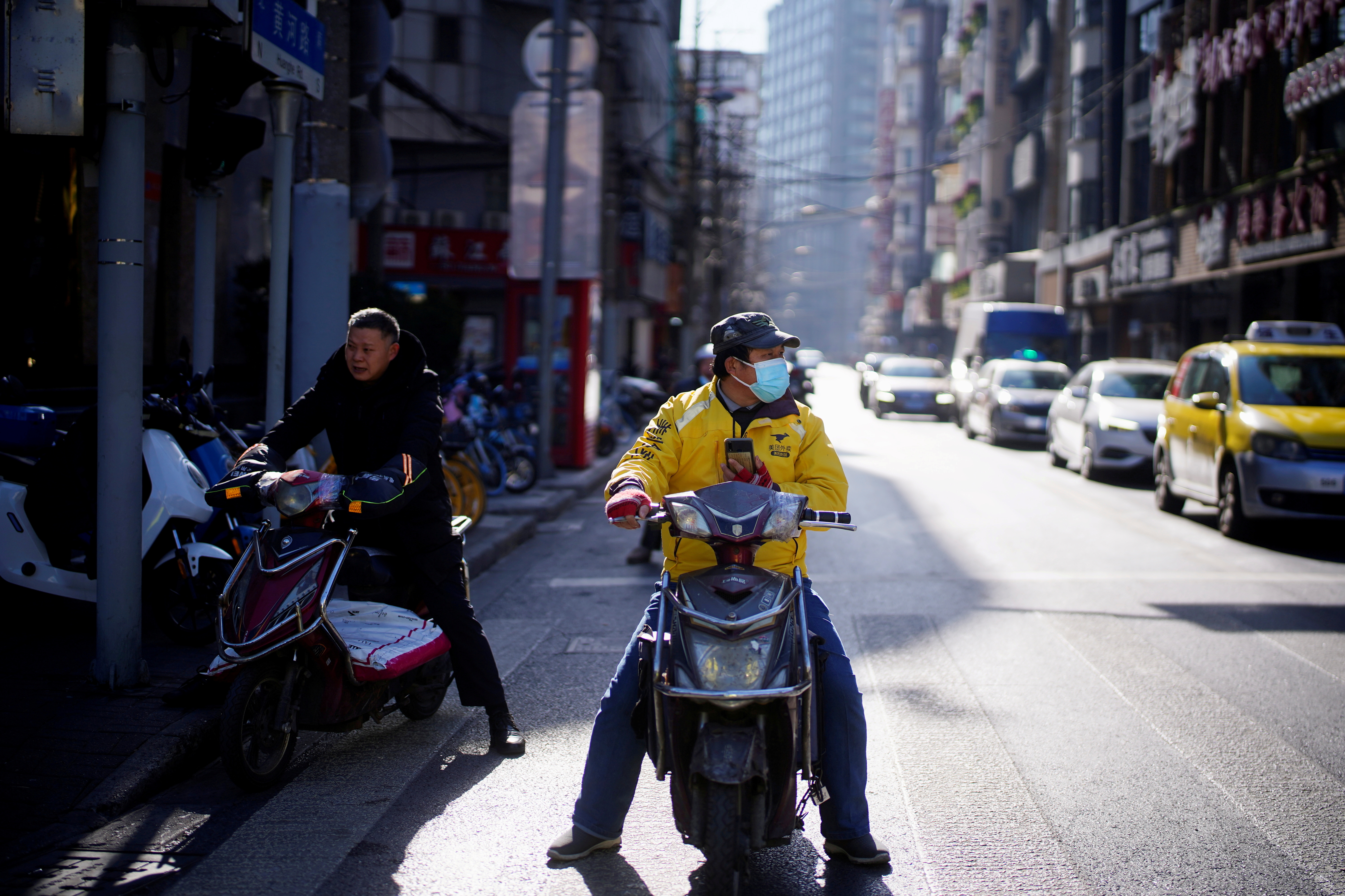 A Meituan delivery worker wearing a face mask is seen on a street following an outbreak of the coronavirus disease (COVID-19) in Shanghai